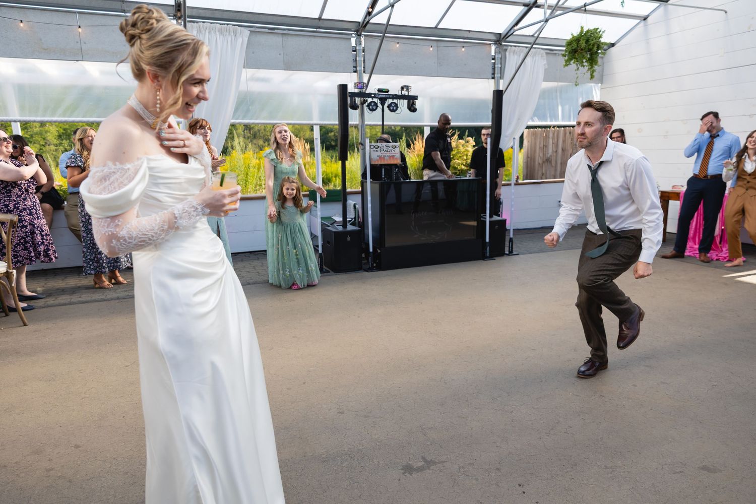 Wedding guests dance together in a sequence of candid moments during a lively reception celebration.