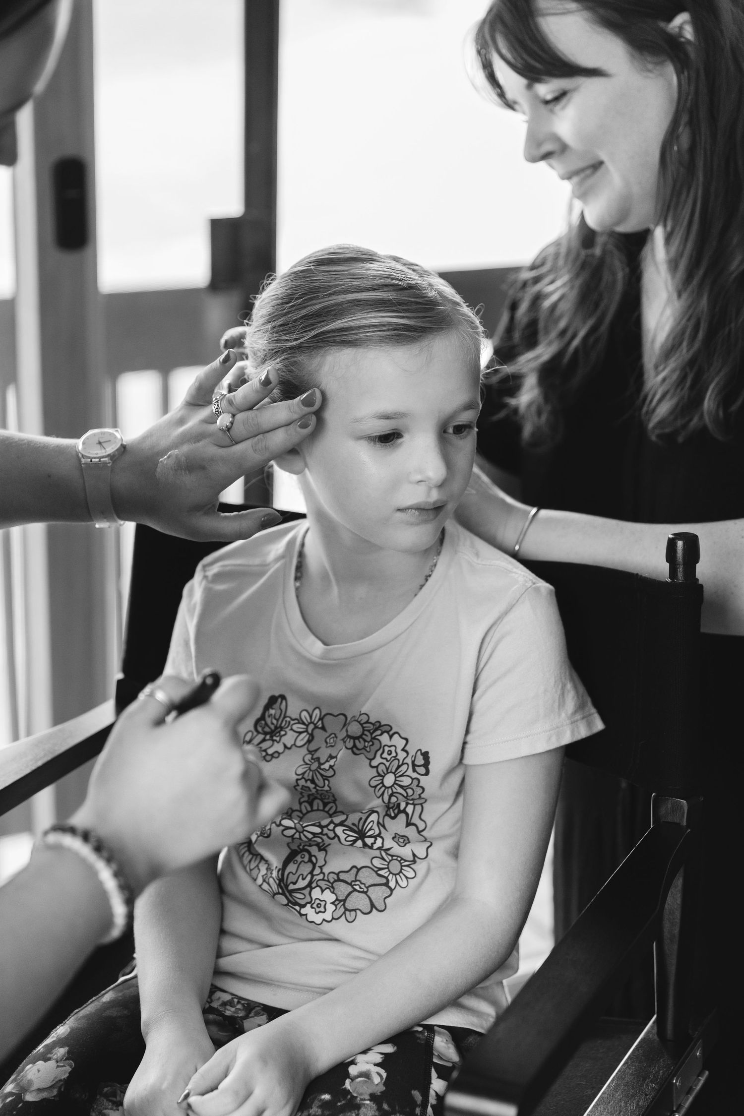 Black and white image of styling session with brushes and tools.