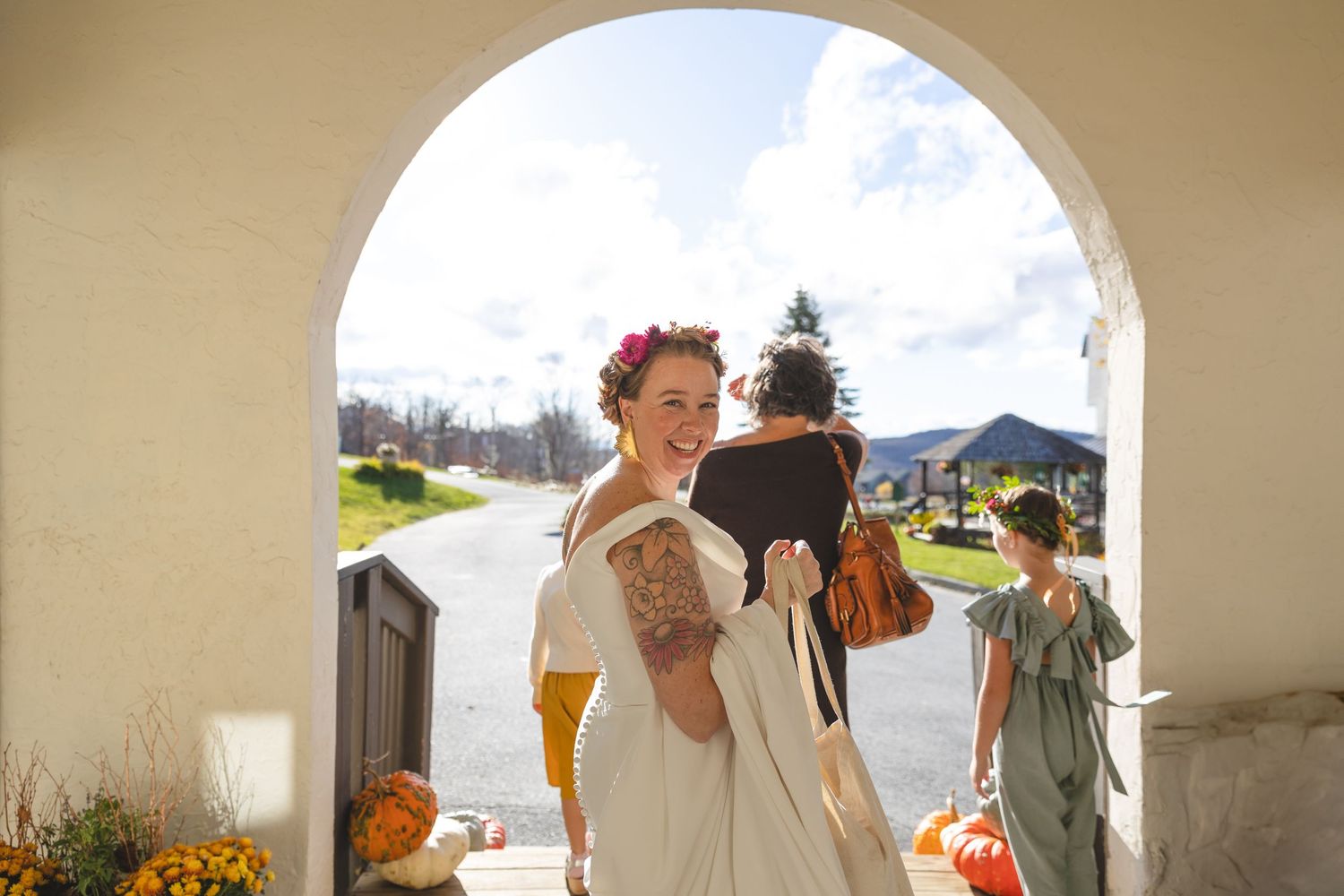 Bridal portrait under arched doorway with mountain scenery.
