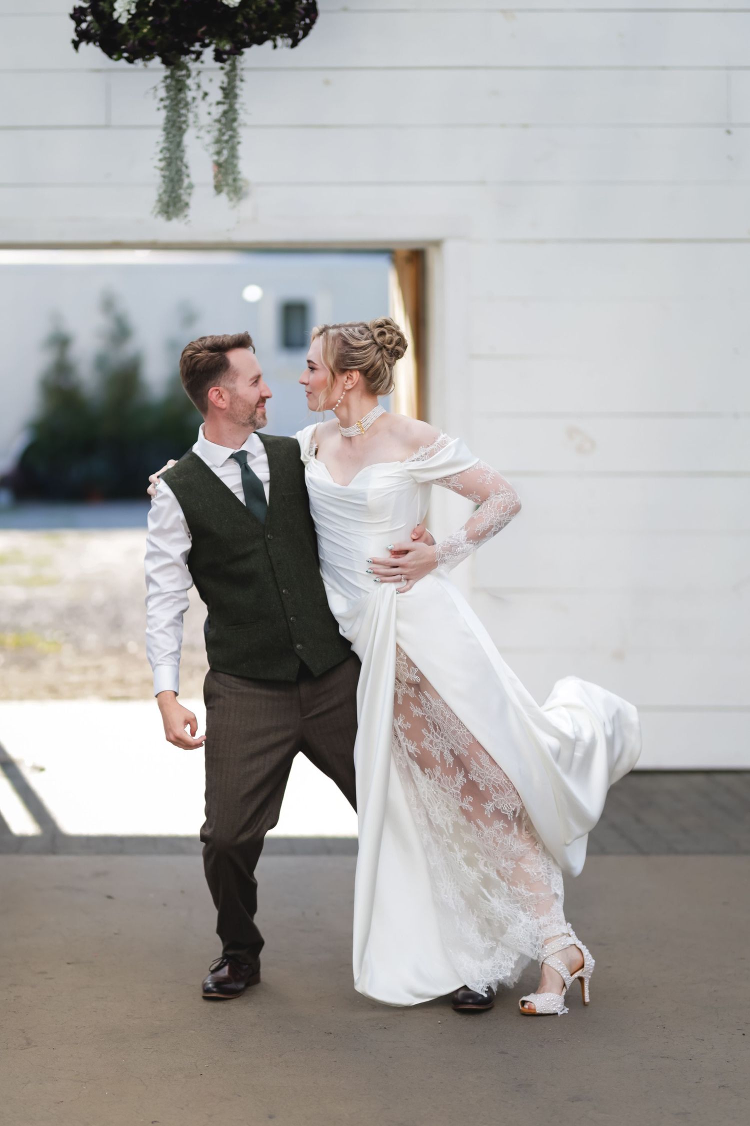 A romantic wedding couple dances together on a concrete patio in a series of four connected photos.