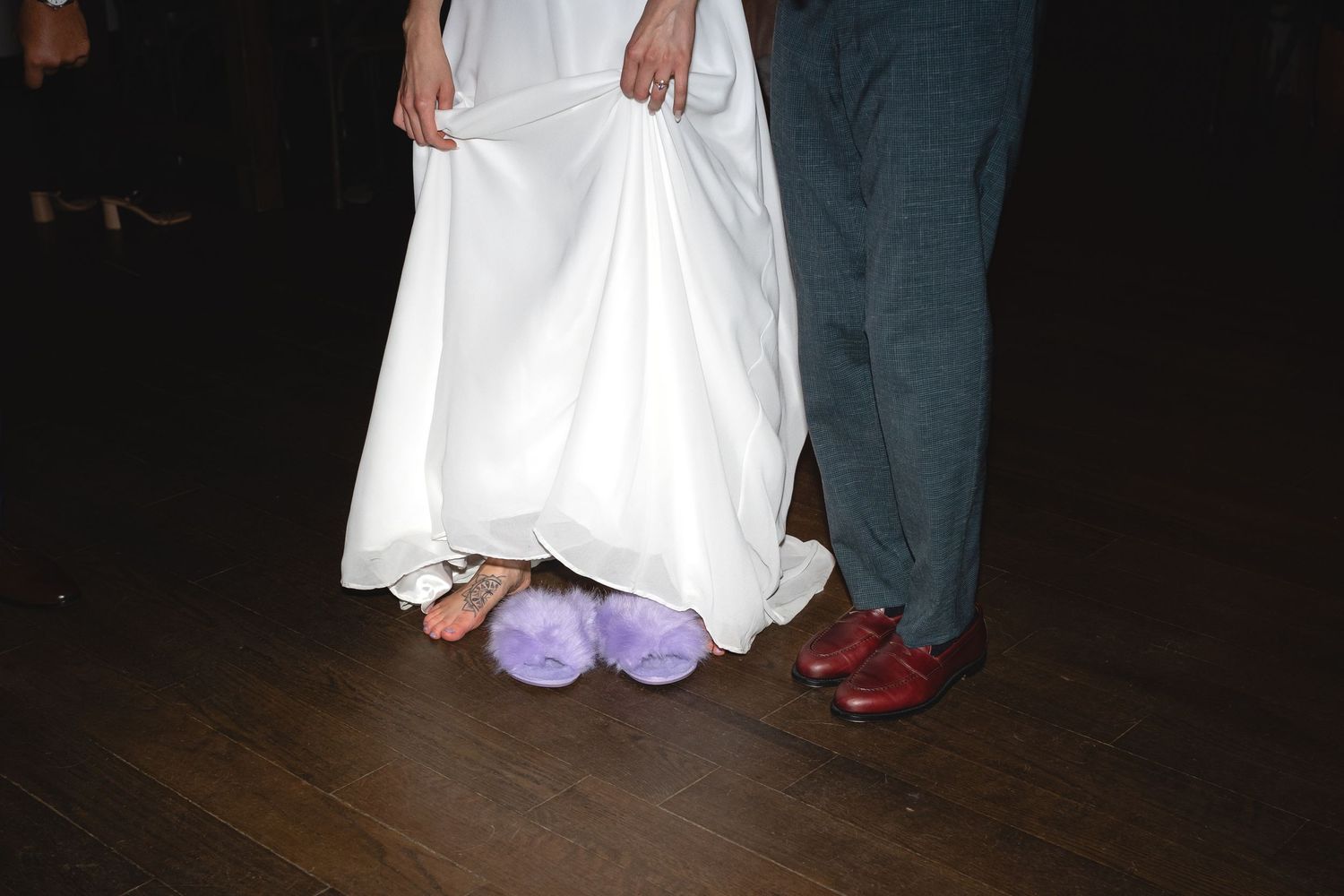 A close-up shot of dance shoes on a wooden floor during a wedding reception.