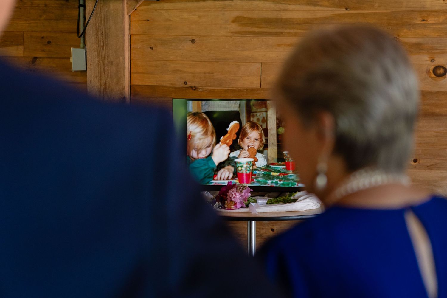Wedding guests watching a presentation or speech during the reception.
