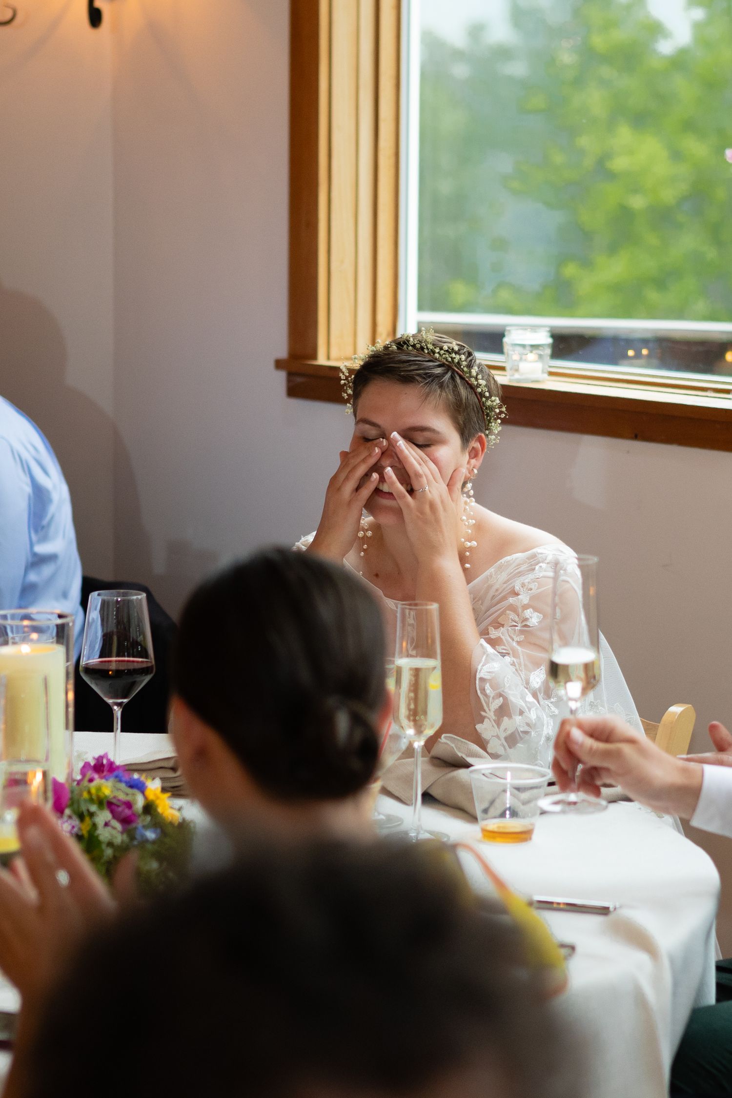 Wedding reception guest having an emotional moment during dinner.