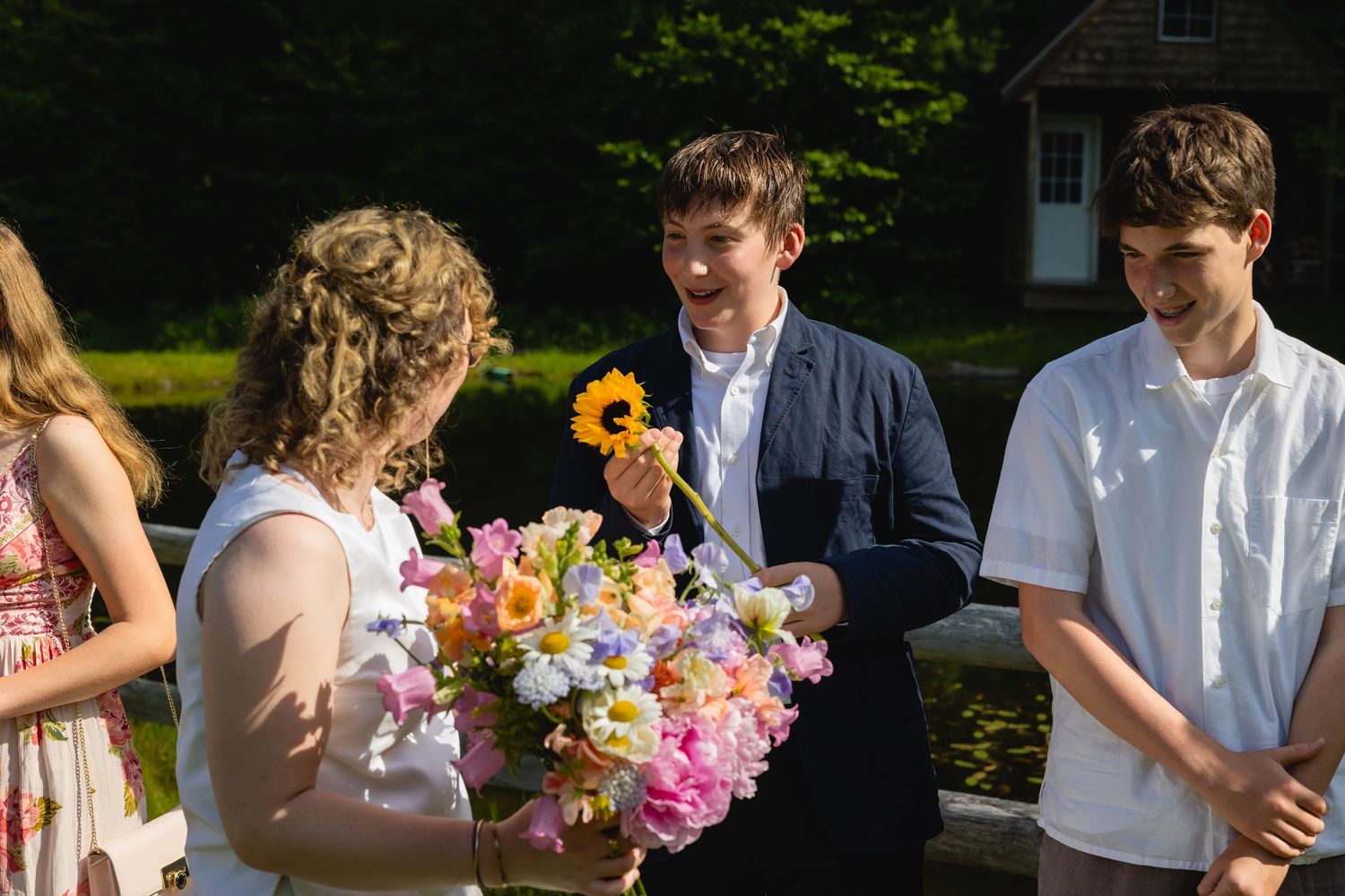 A panoramic collage of an outdoor wedding celebration showing guests mingling and holding colorful flower bouquets.