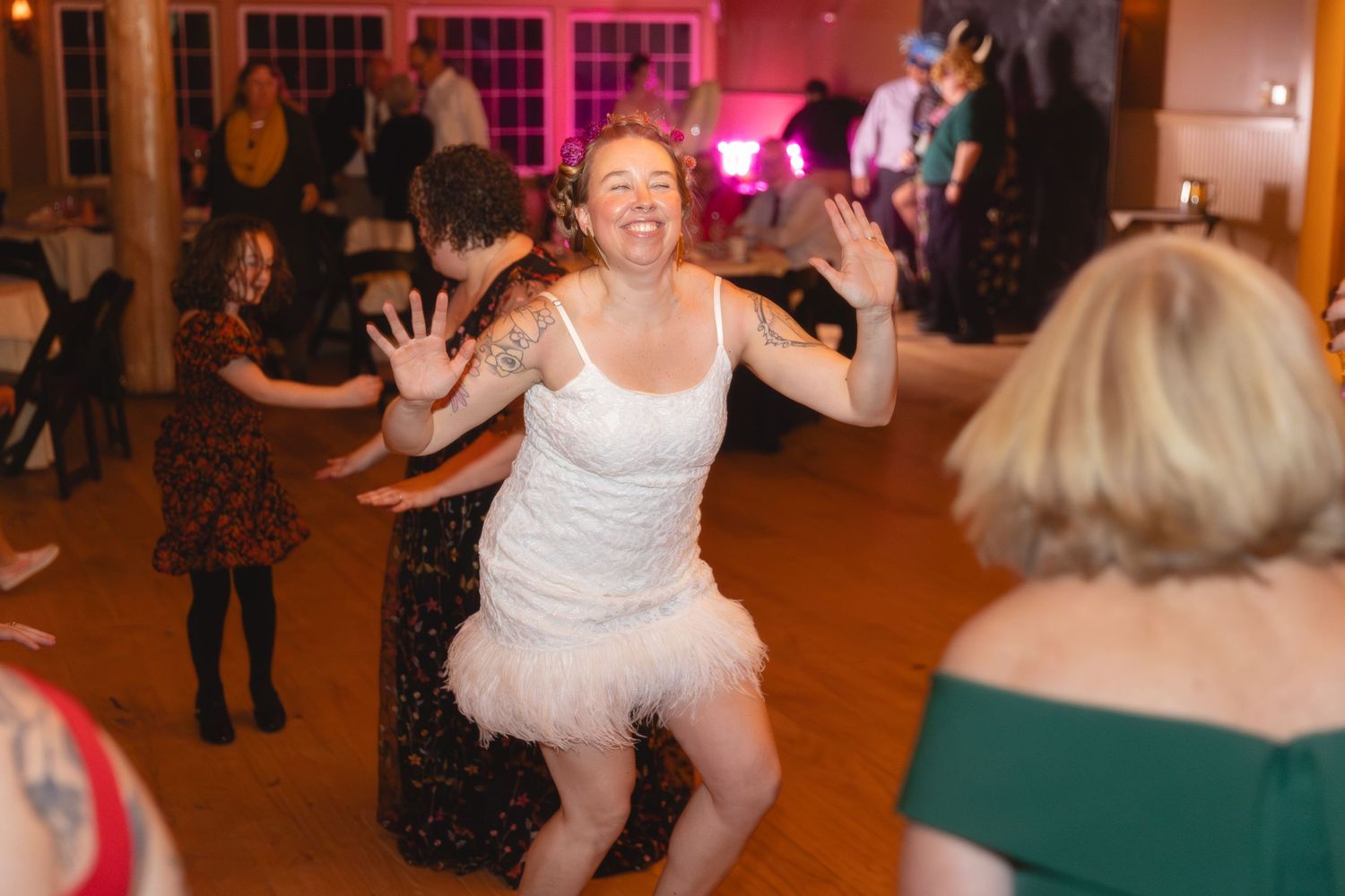 A celebratory moment captured on the dance floor at a wedding reception.