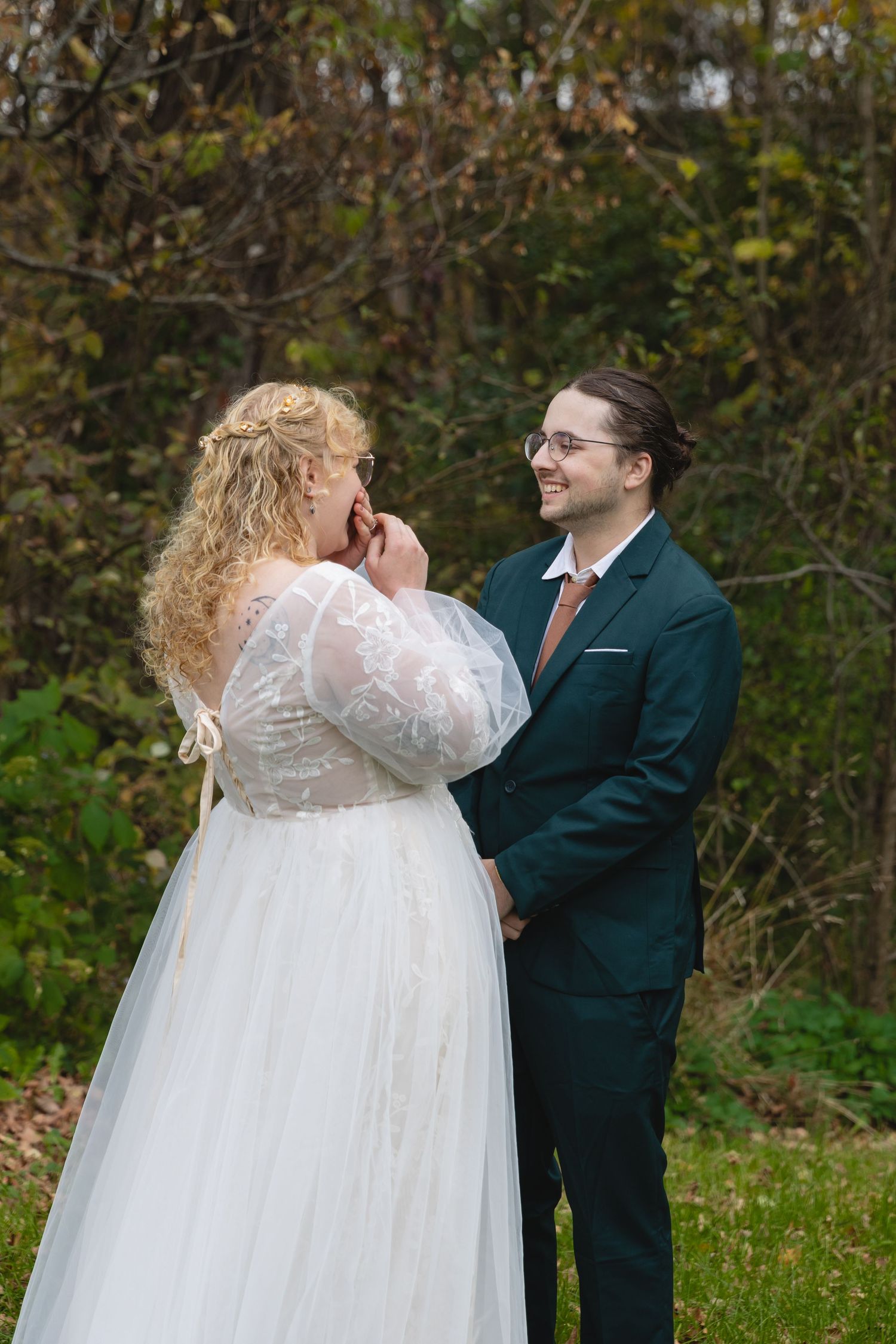 Sweet candid moment between couple during autumn outdoor wedding.