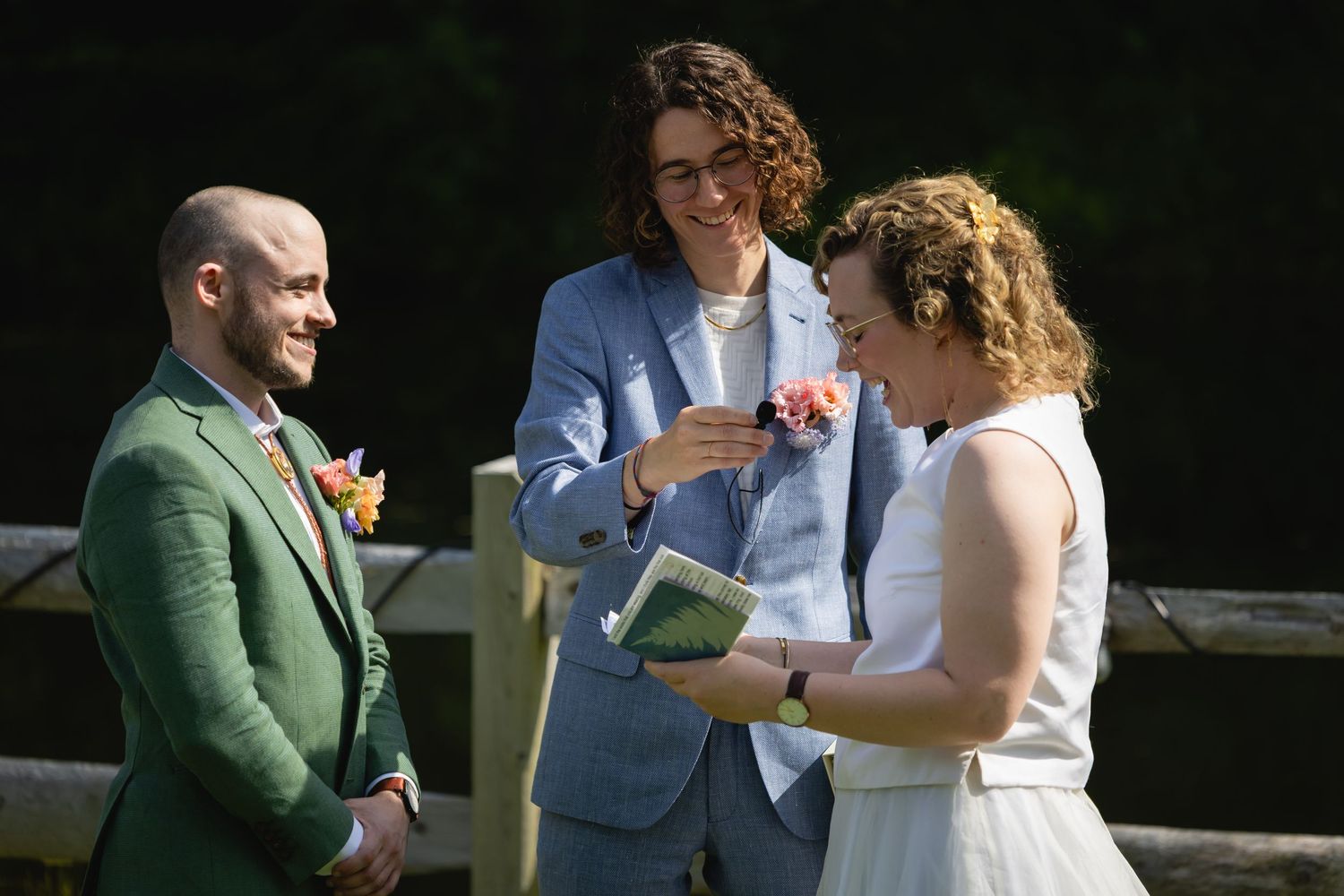 Wedding couple shares an intimate moment during an outdoor celebration in natural lighting.