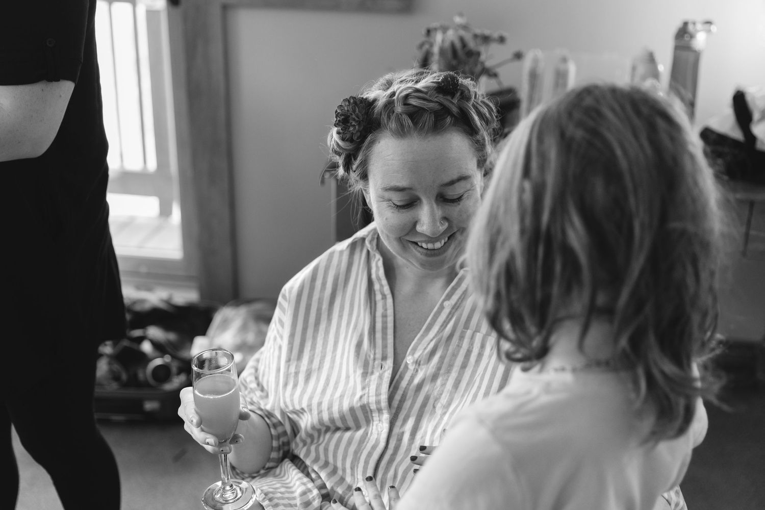 Black and white candid moment of morning preparations with coffee and laughter.