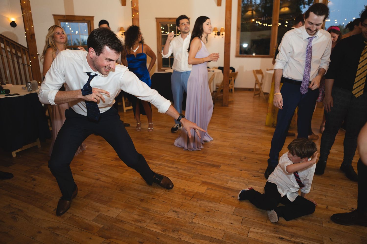 Dynamic dance moves on display during lively wedding reception festivities.