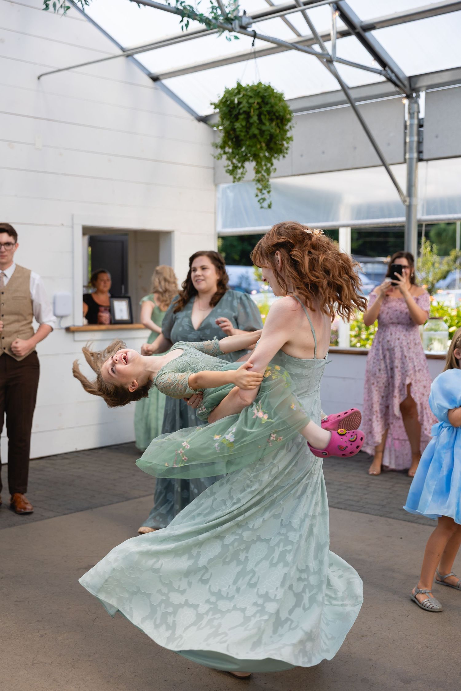 A sequence of dance movements shows a flowing mint green dress twirling gracefully at what appears to be a party or celebration.
