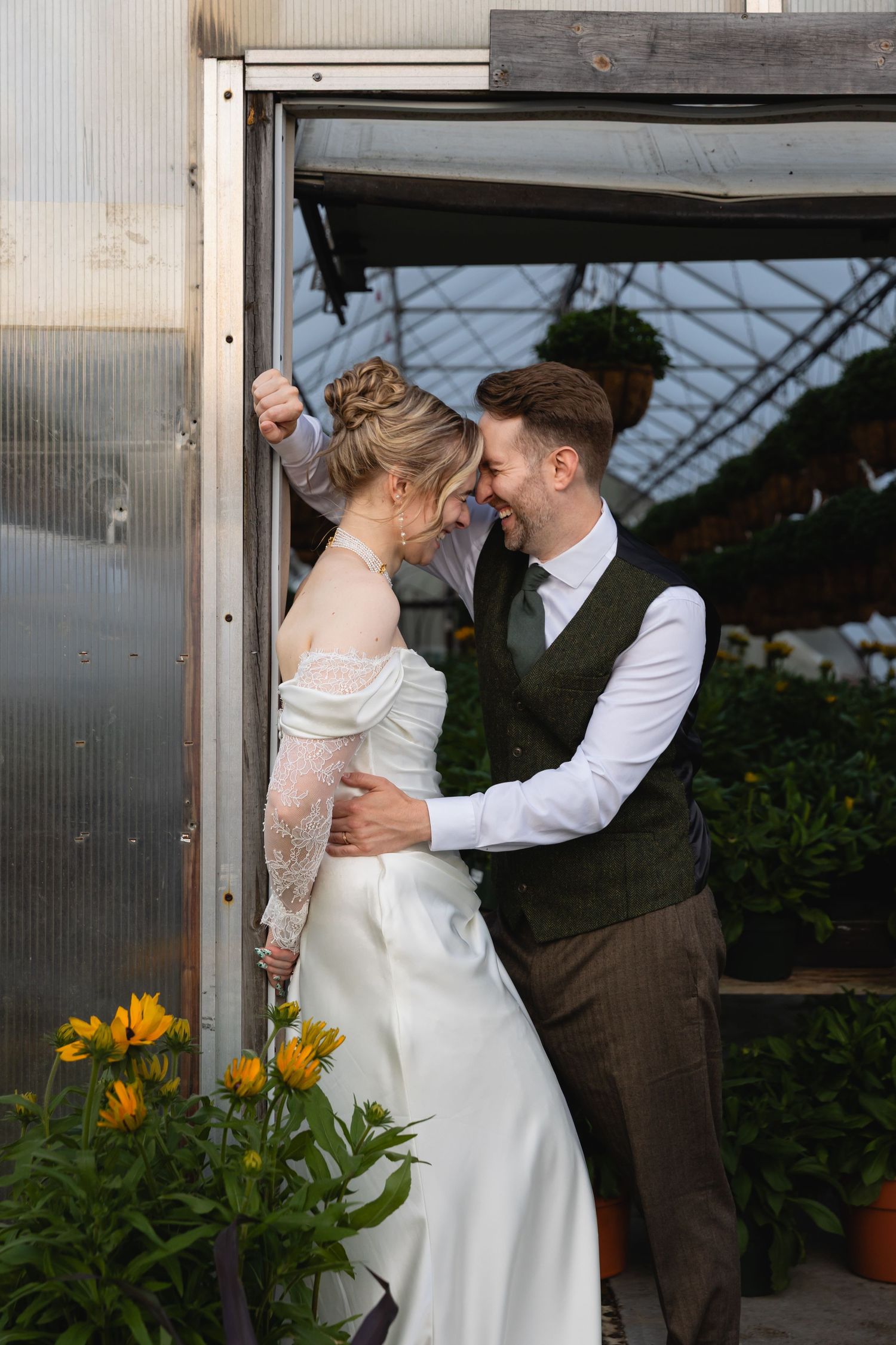 A romantic wedding photoshoot sequence showing a couple embracing in front of a greenhouse with yellow flowers.