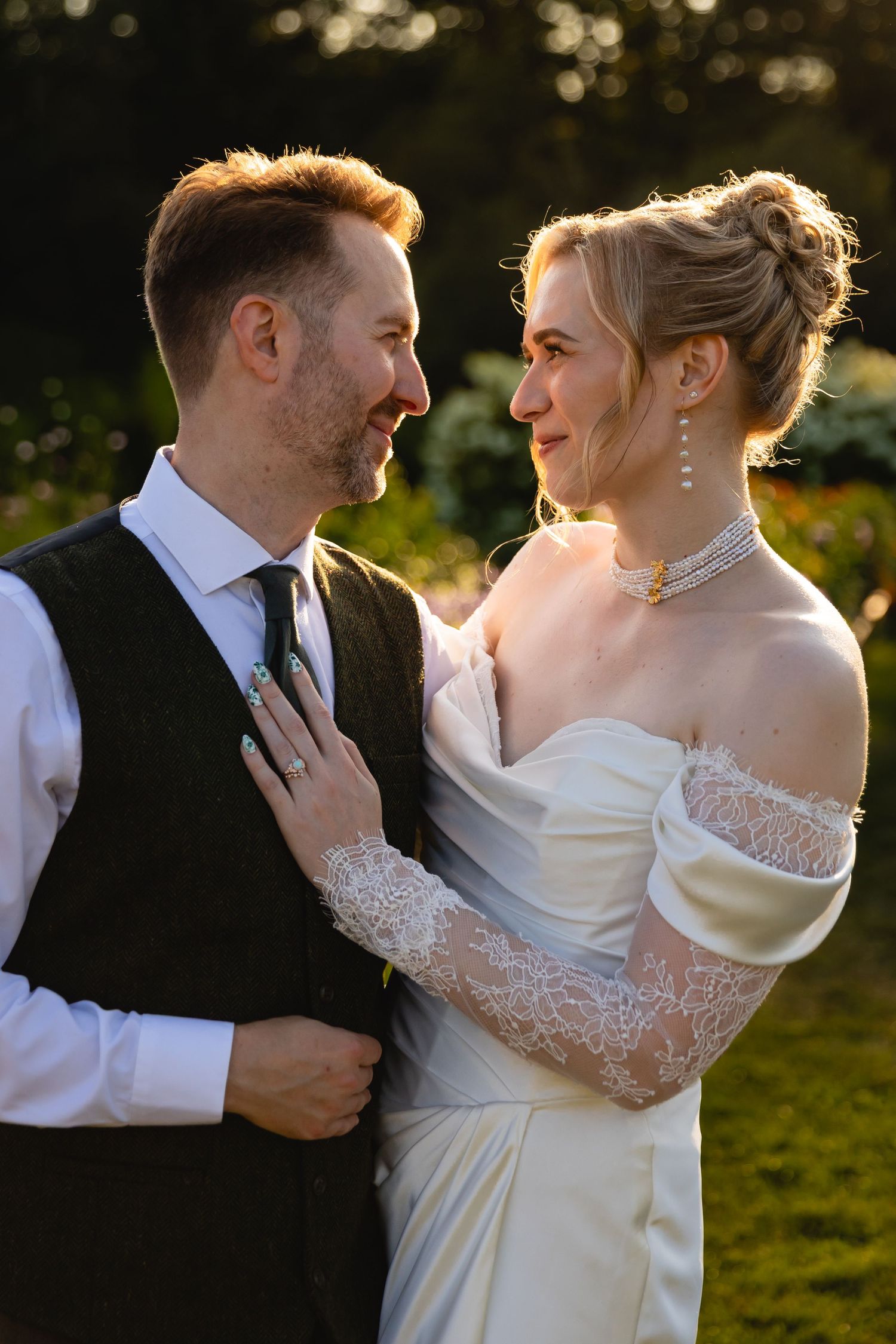 Intimate wedding portraits captured during golden hour showing tender moments between newlyweds in a garden setting.