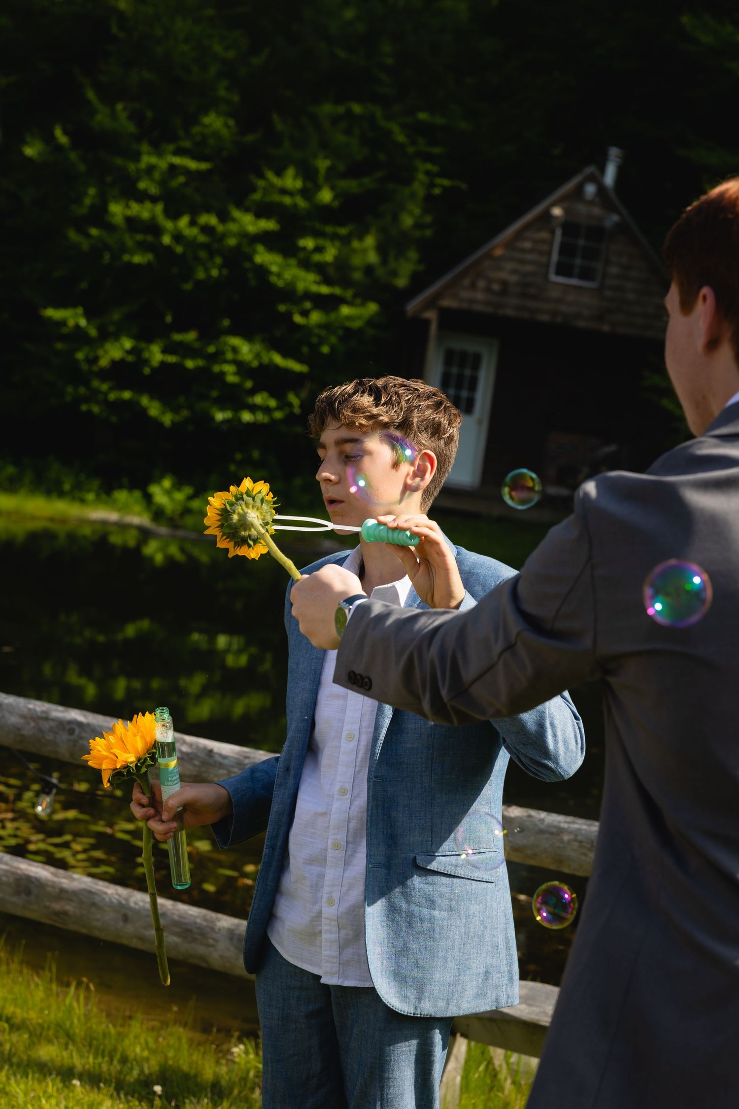 Children play with bubbles and sunflowers in a garden on a sunny summer afternoon.