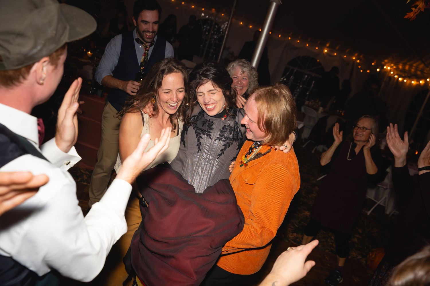 People dancing and having fun at a lively nighttime party or celebration event.