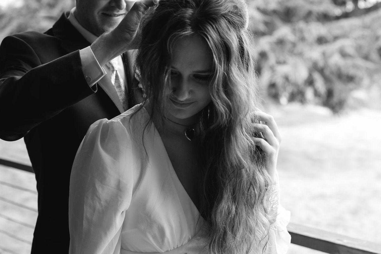 A series of romantic black and white photographs showing intimate moments between a couple on their wedding day.