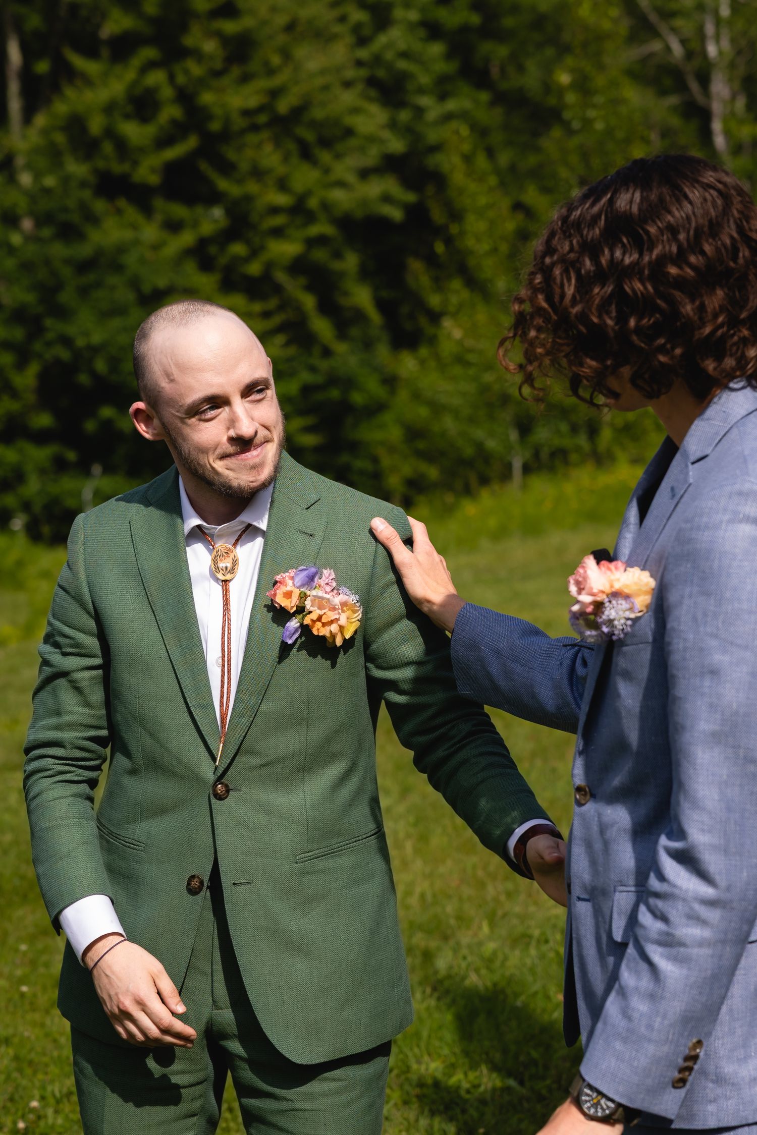 A sequence of candid moments showing two people in formal attire interacting playfully outdoors against a green forest backdrop.