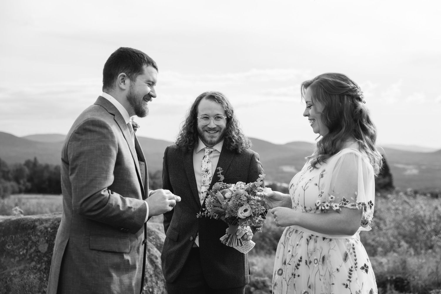 A couple shares joyful moments together in a scenic outdoor setting during their wedding celebration.