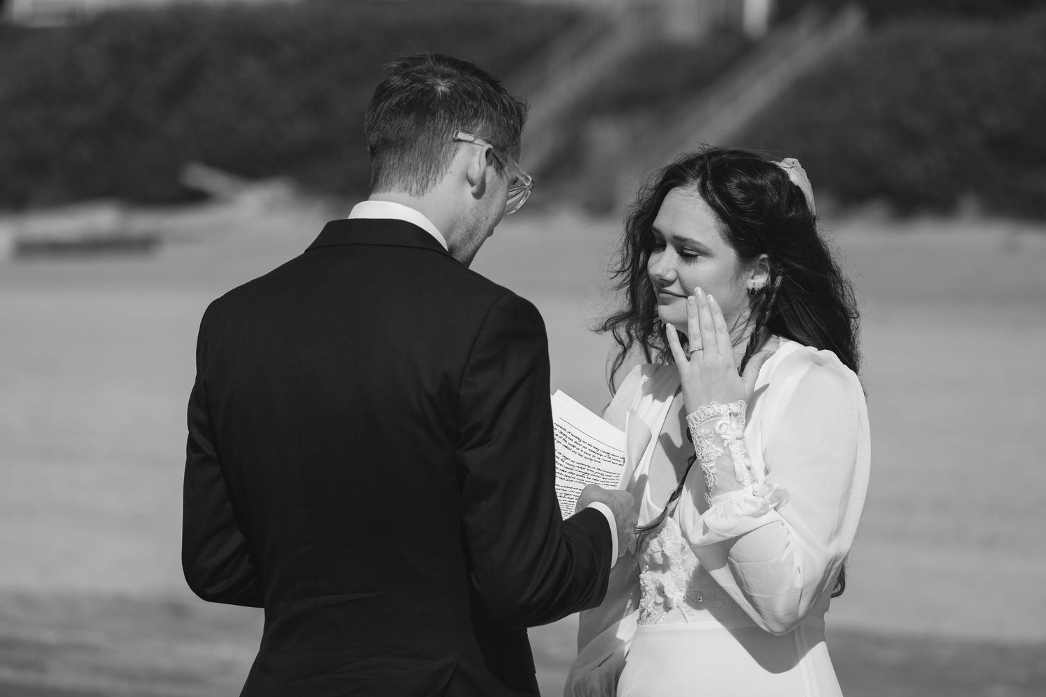 A series of black and white wedding photographs showing romantic moments between a bride and groom outdoors.
