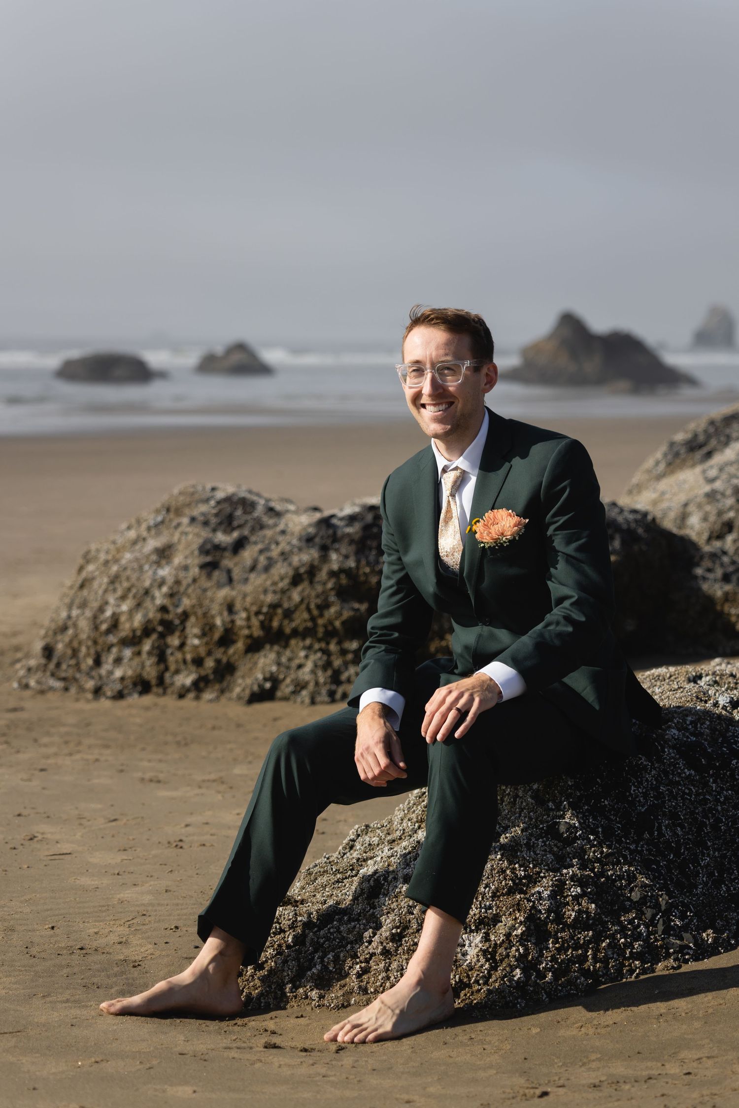 A series of candid beach photos showing a suited figure sitting on coastal rocks at the ocean.