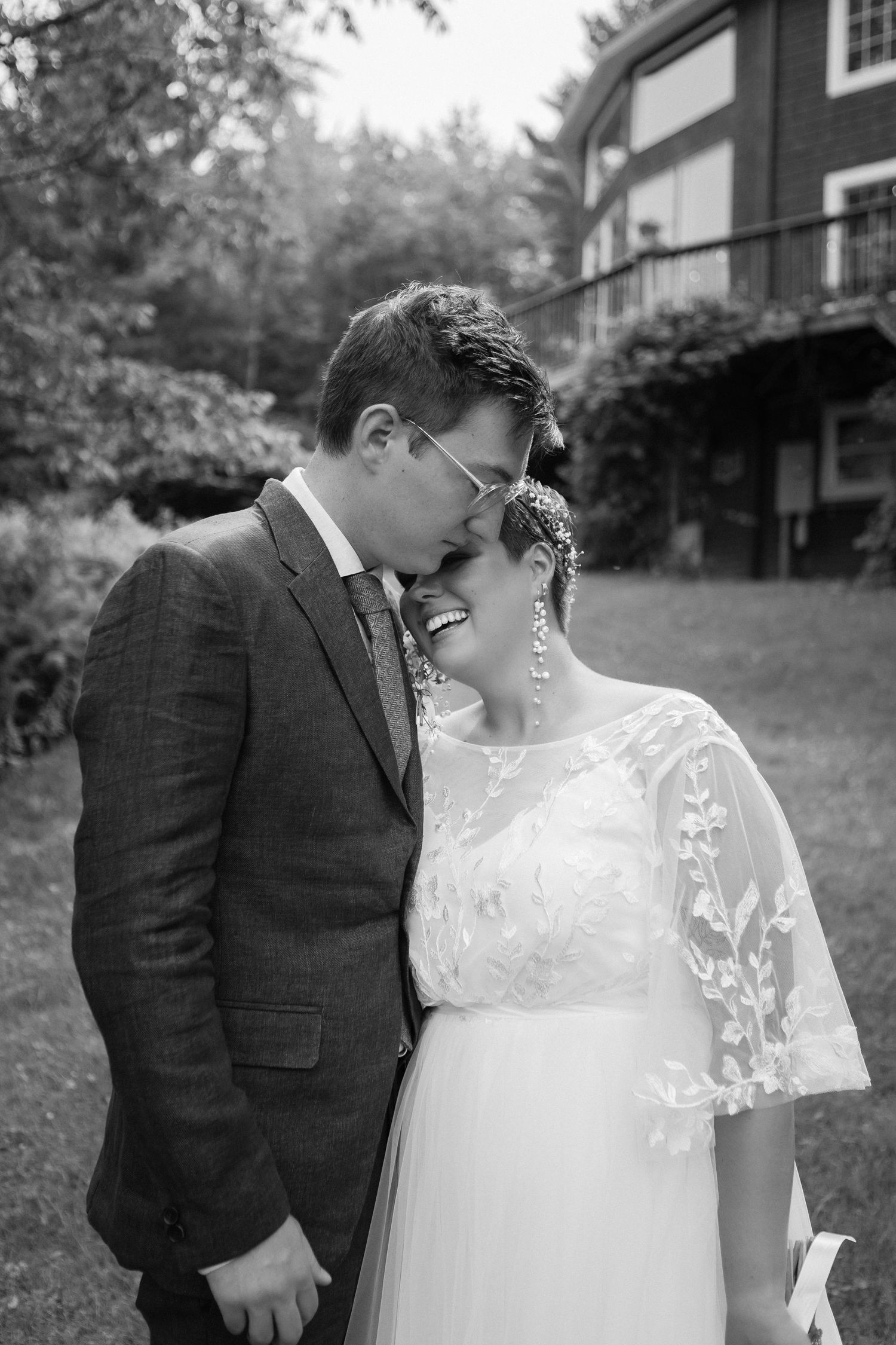 Intimate black and white wedding portrait captured in front of historic building.