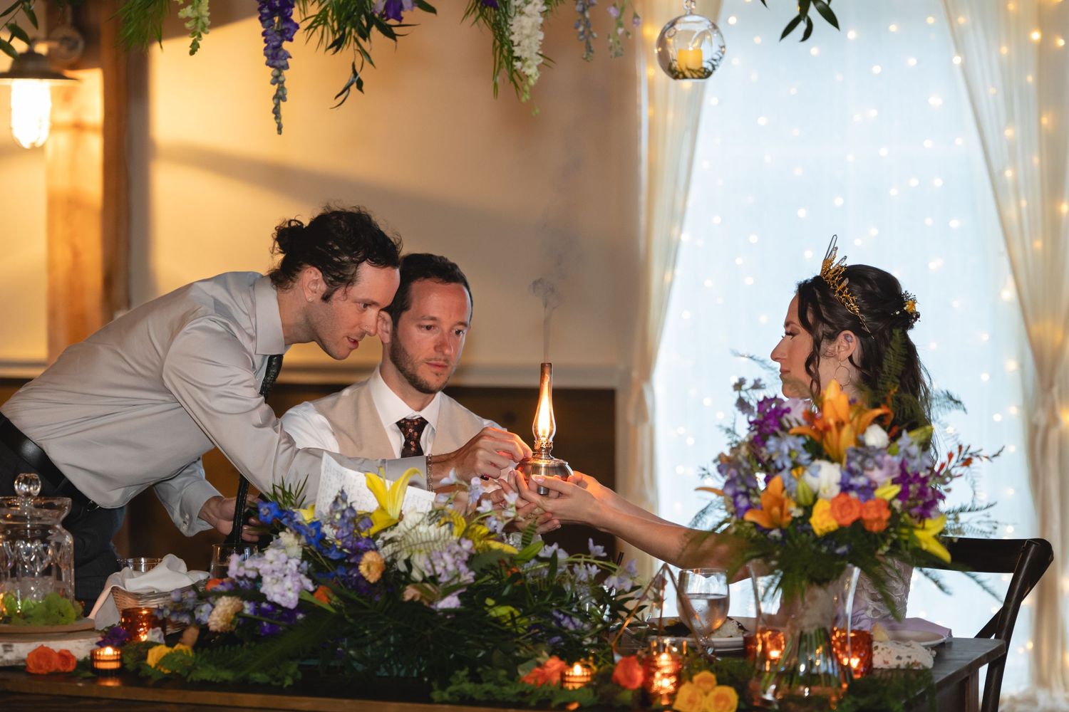 Wedding reception scene with guests interacting at decorated dinner table.