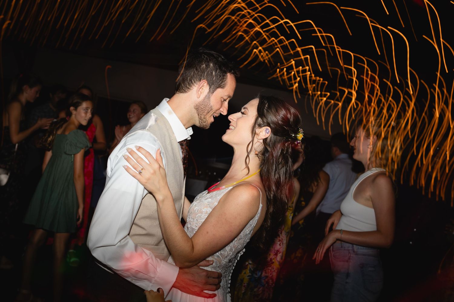 A couple dancing at their wedding reception with light trails creating a dreamy atmosphere.
