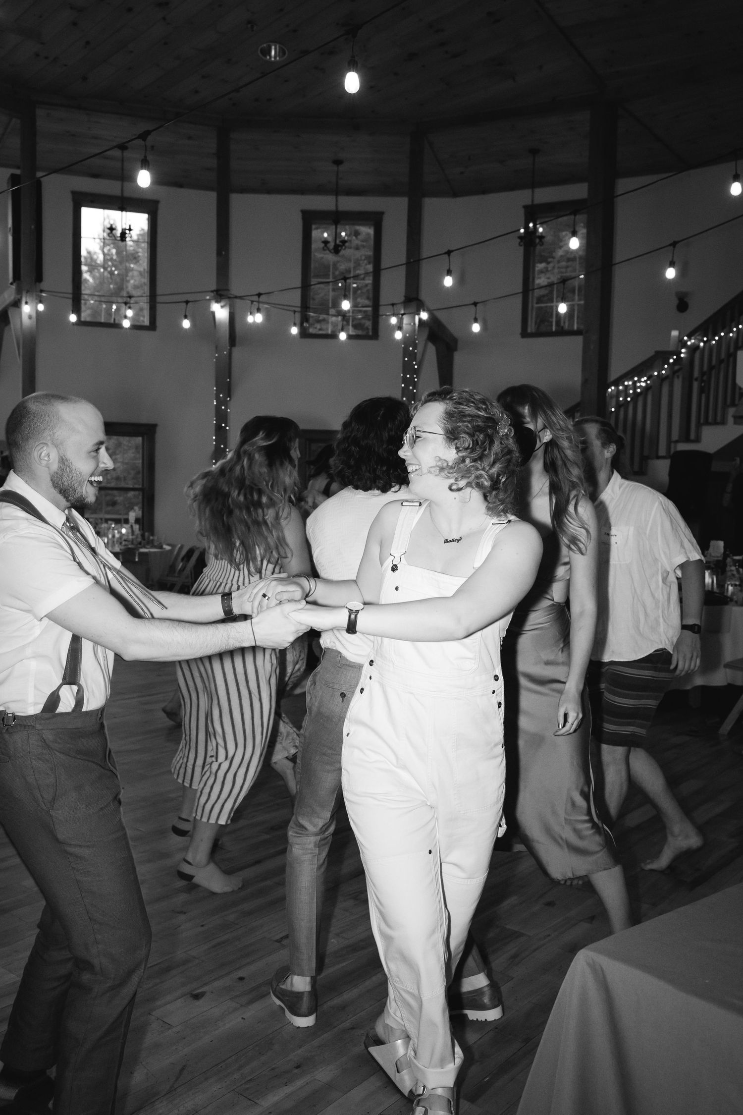Couples dance together in a vintage black and white photo series showing swing dance moves at a social gathering.