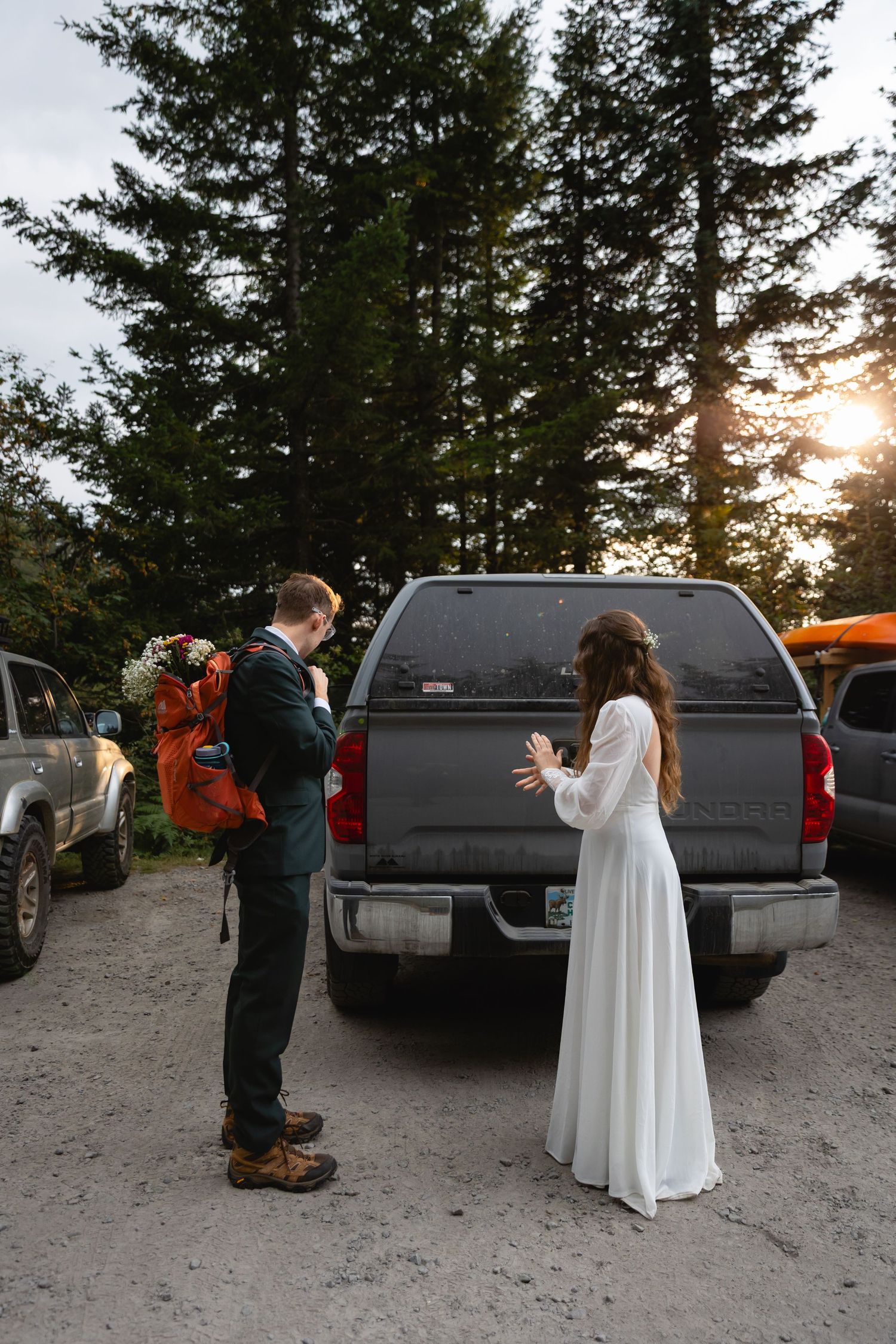 A playful Halloween-themed wedding photo series shows a ghost chasing someone through a parking lot at sunset.