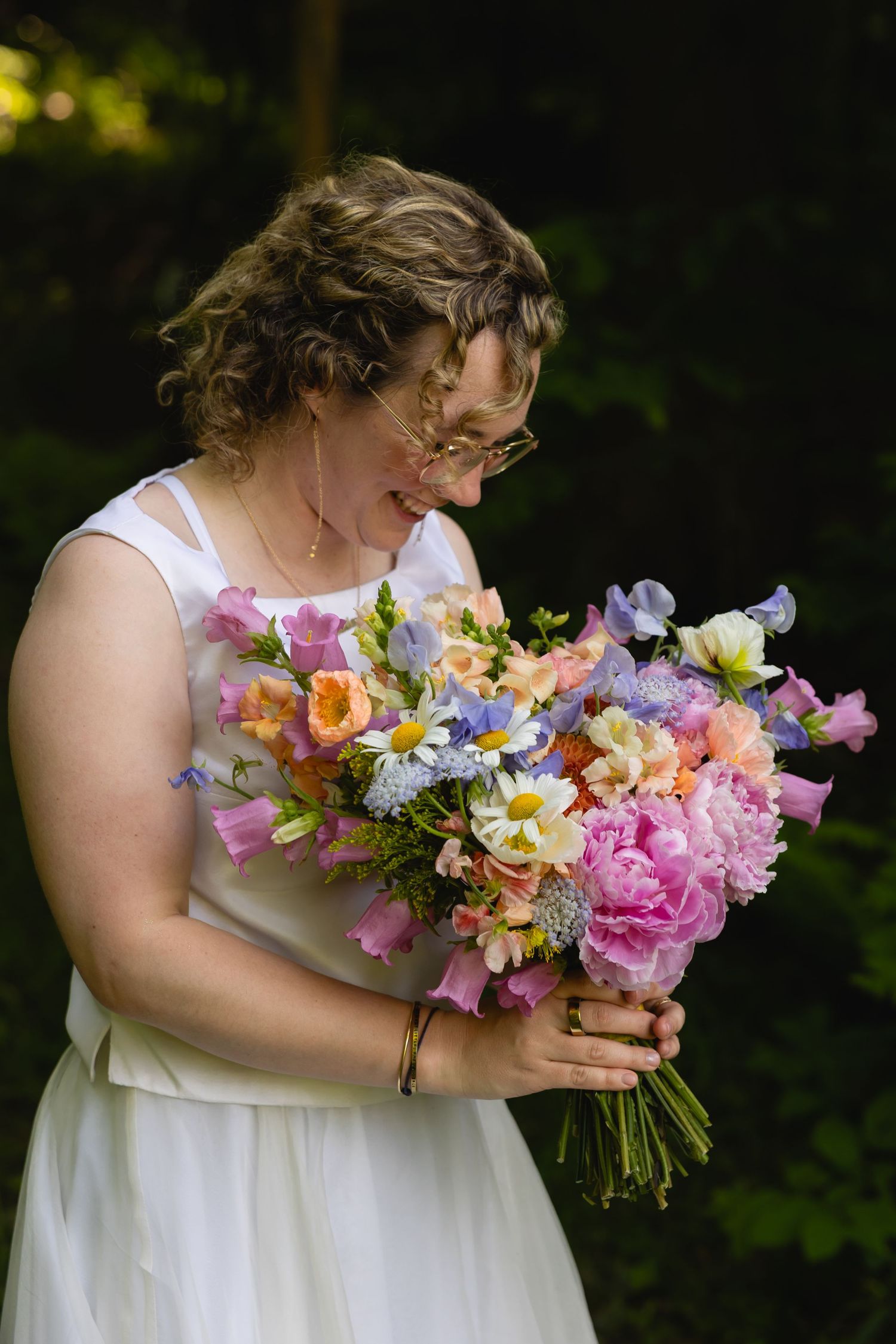 A series of photos showing a colorful bouquet of peonies, daisies and mixed flowers held against a white dress.