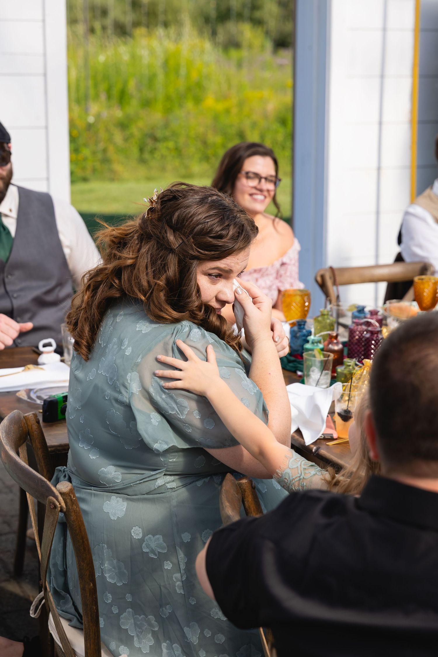 Candid sequence of people sharing laughter and drinks at an outdoor gathering.