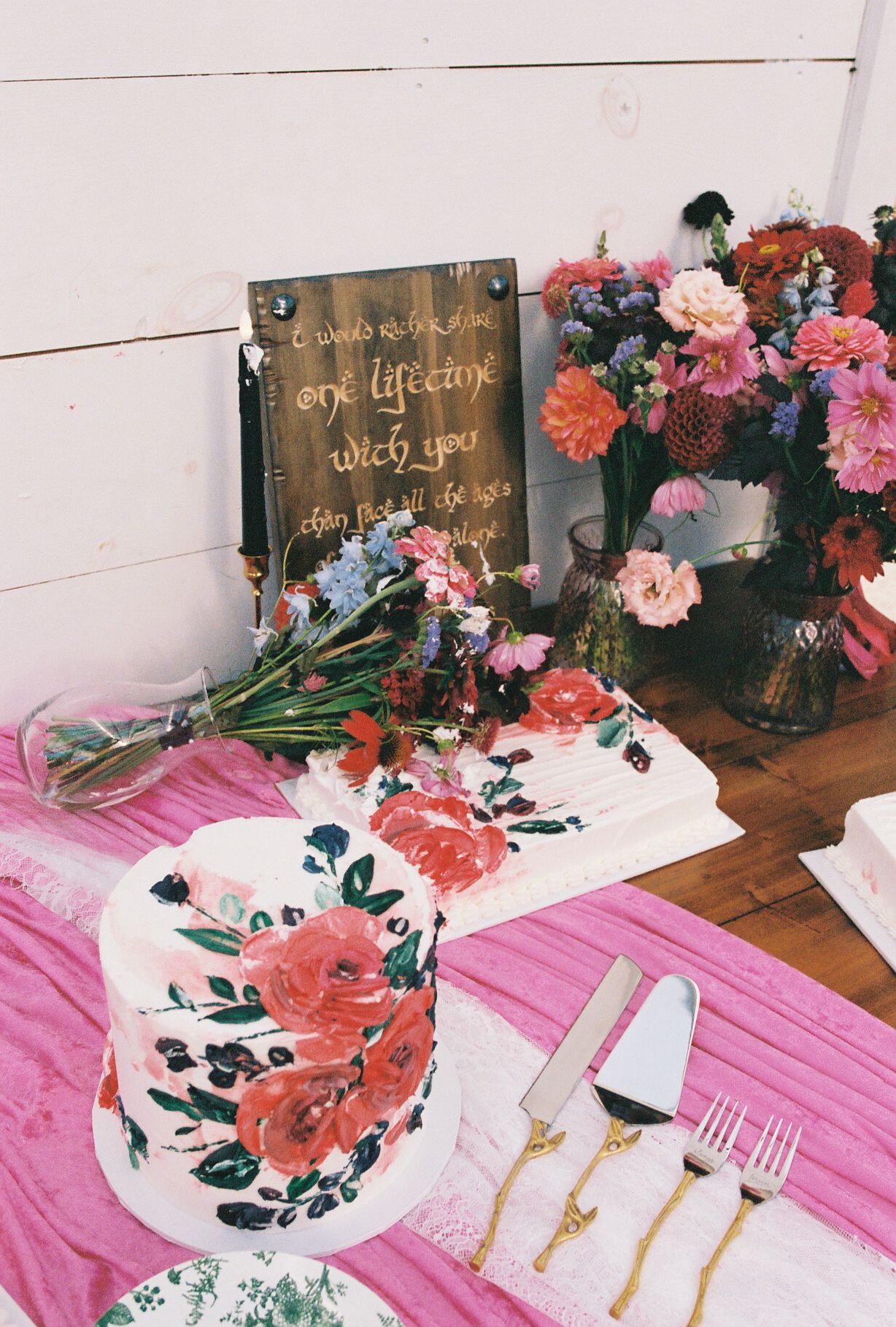 A series of elegant table settings with pink linens and coral flowers arranged alongside golden cutlery and decorative plates.