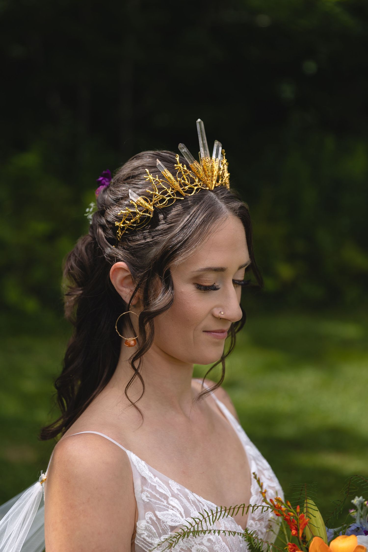 Close-up of intricate golden crown headpiece with delicate details worn at an outdoor wedding.