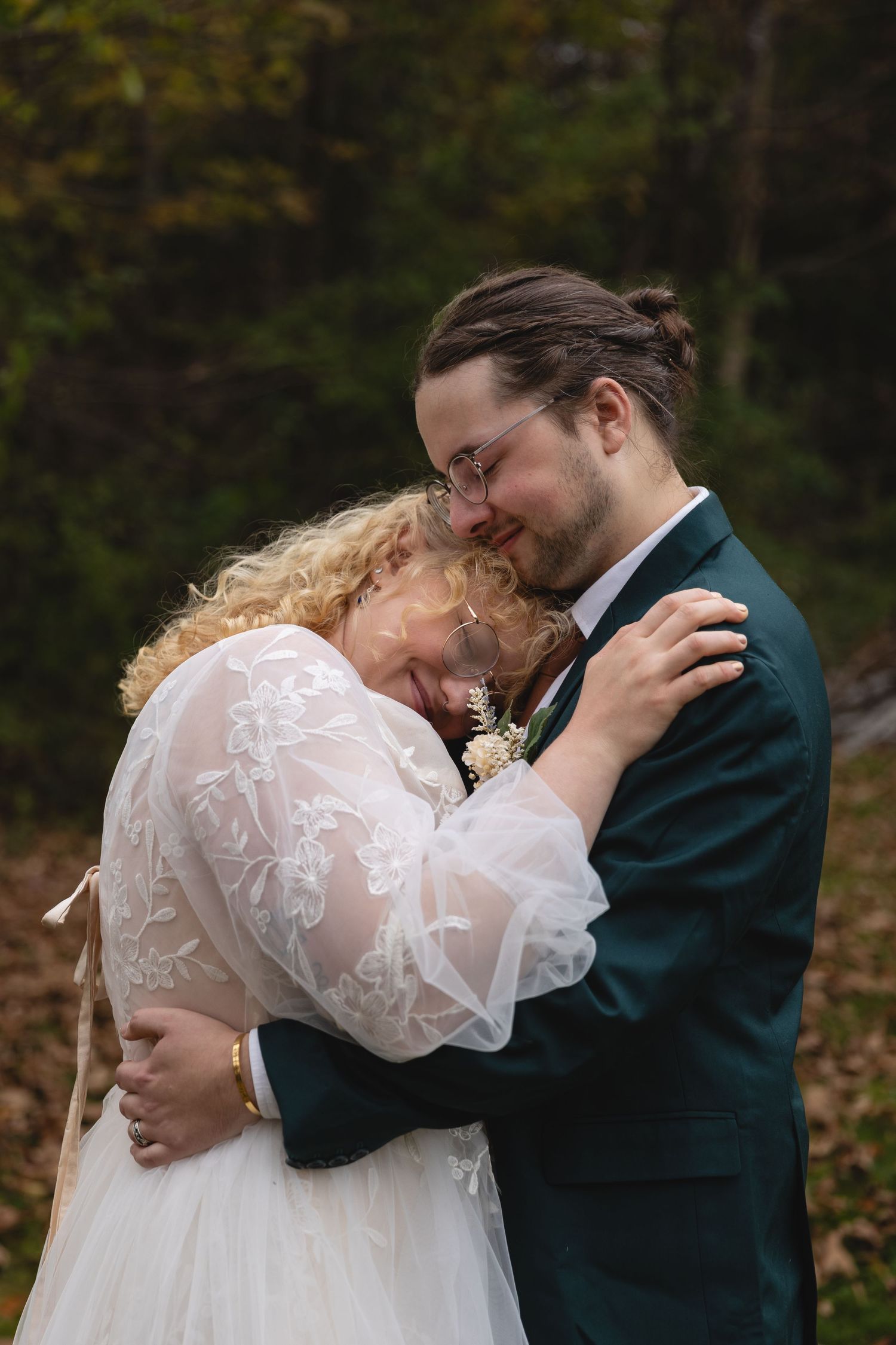 A tender embrace between newlyweds during their autumn wedding celebration.