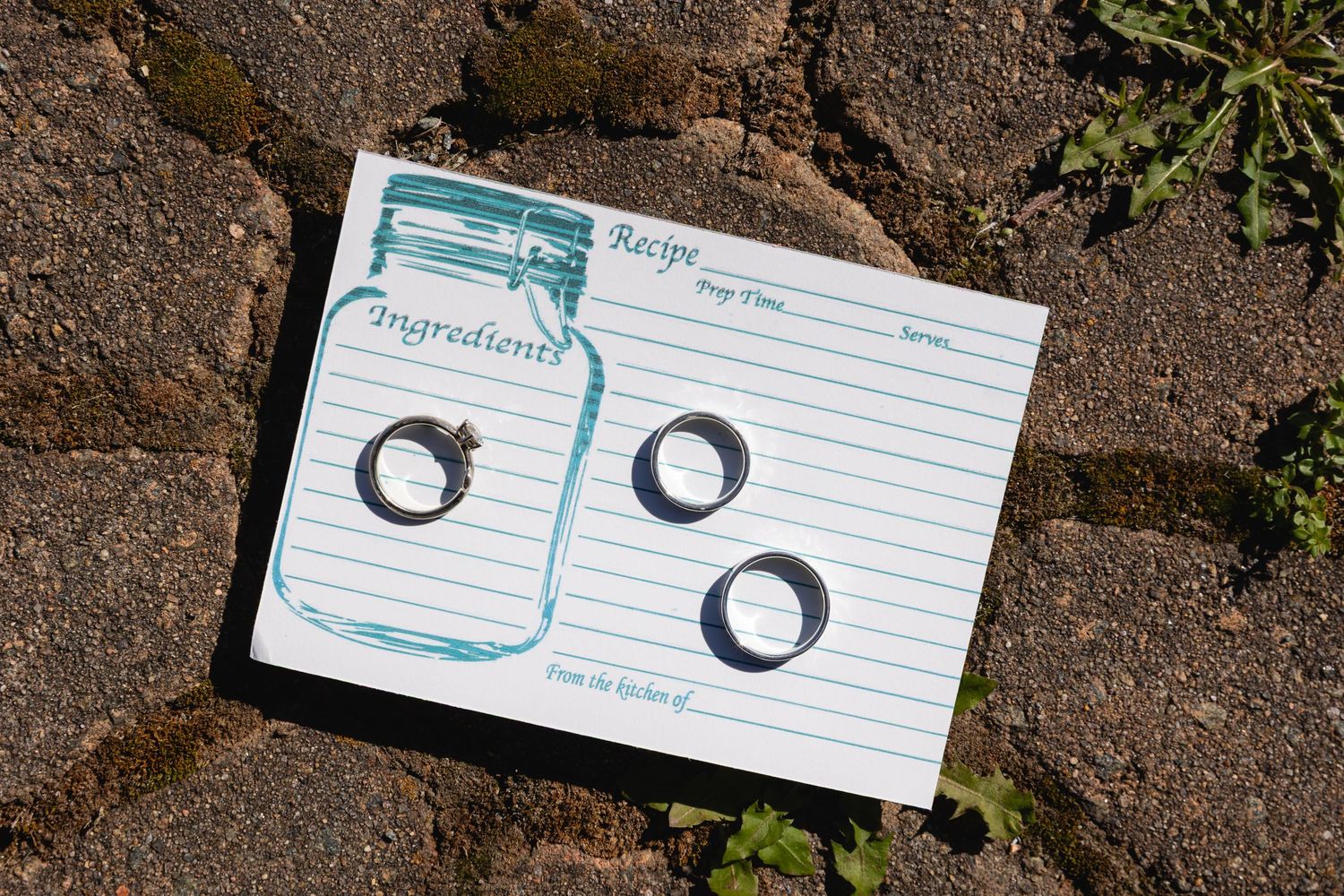 Lined index cards with handwritten notes and symbols arranged on a stone or concrete surface.