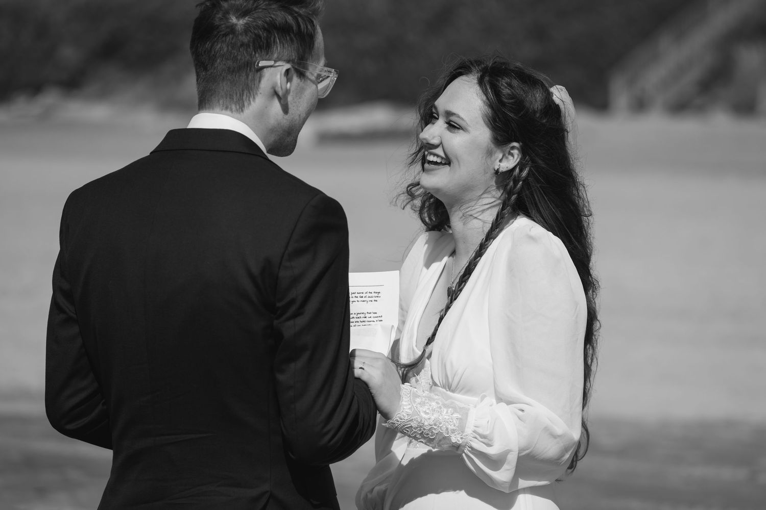 A black and white photo collage showing joyful moments from a wedding celebration outdoors.