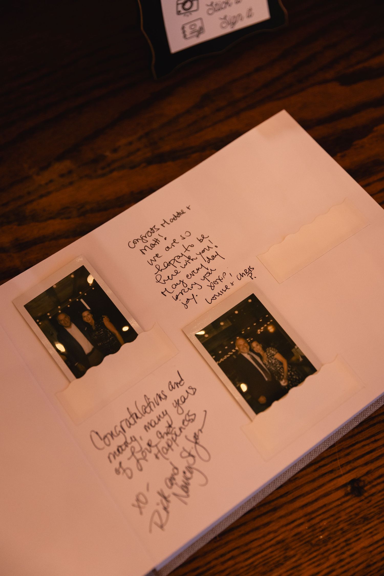 Two small polaroid photos are attached to a white page with handwritten notes surrounding them.