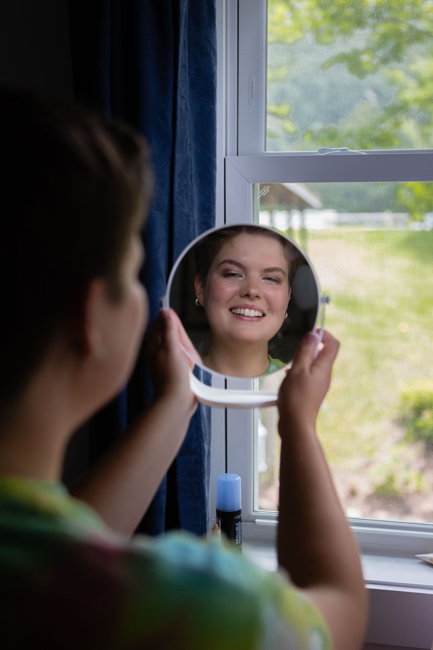 Mirror reflection by window with natural daylight streaming in.
