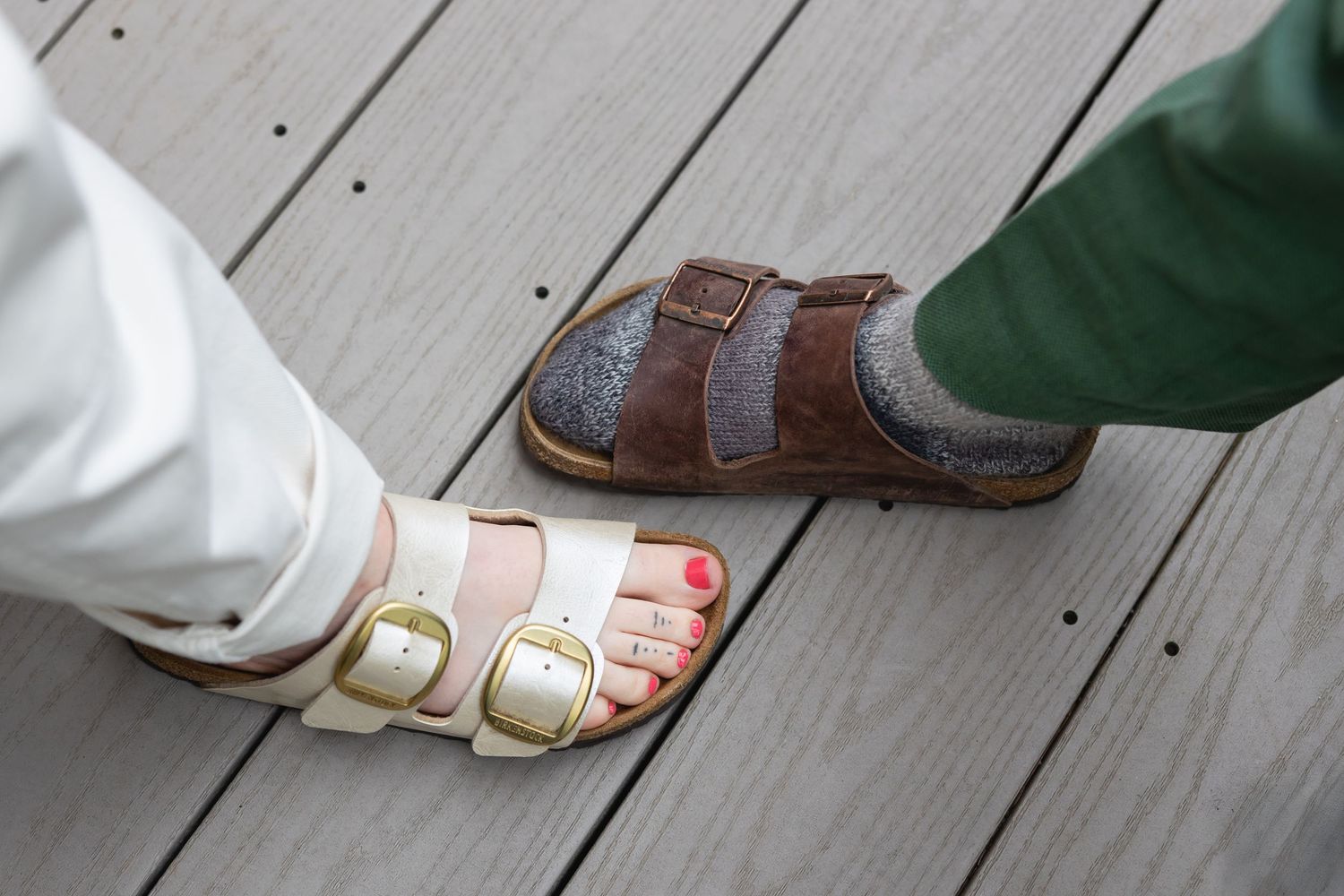 Close-up view of feet dancing on wooden floor showing sandals and dress shoes during a wedding dance.