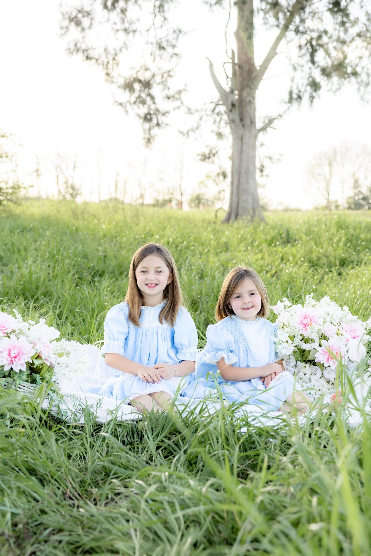 Spring Mini Session with baby chicks in a grass field at sunset near Dothan, Alabama