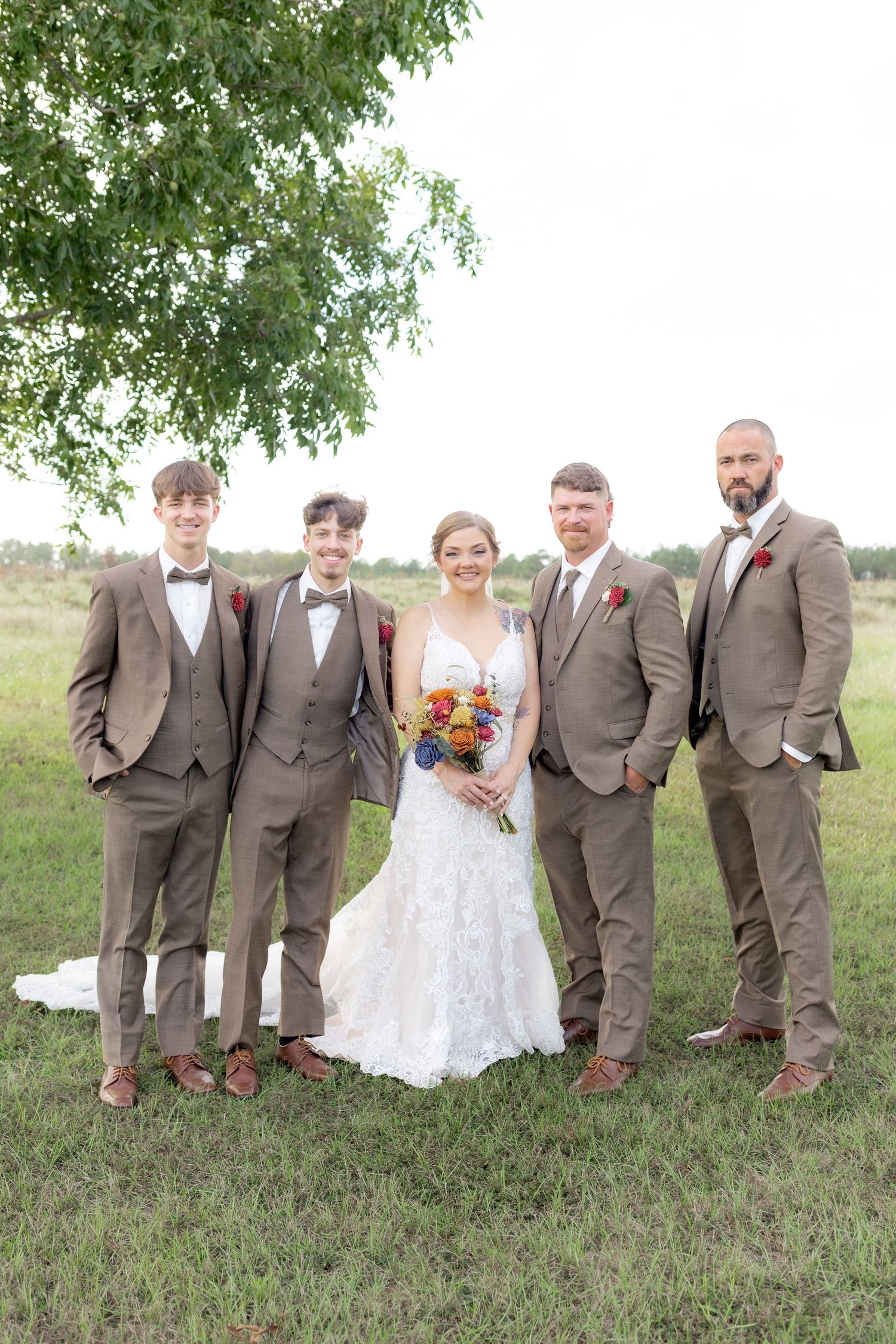 Bridal party posing in a field at sunset at Hilltop Acres Wicksburg, Alabama