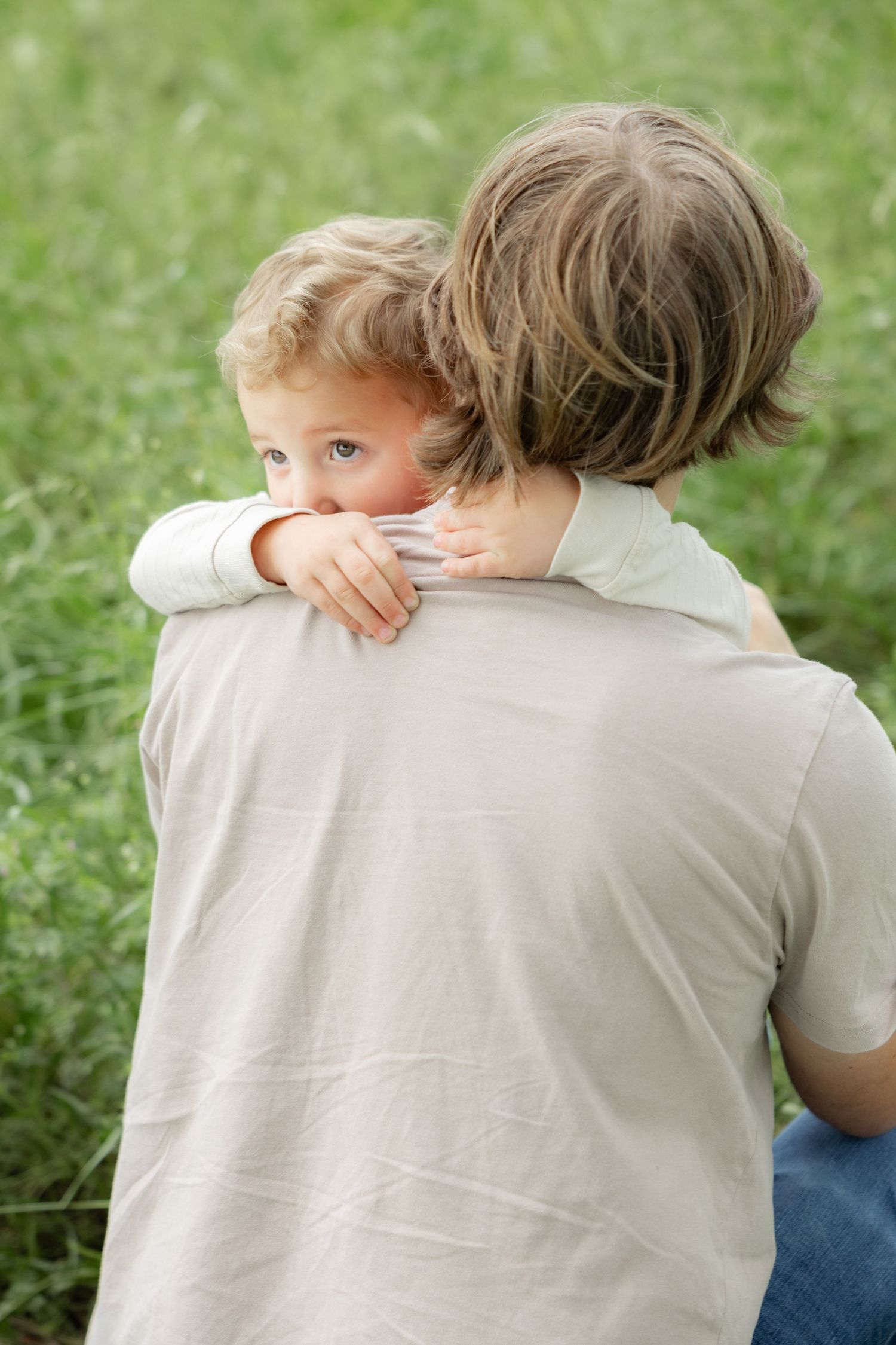 Candid family photos in a grass field | Dothan, Alabama Lifestyle Portrait Photographer