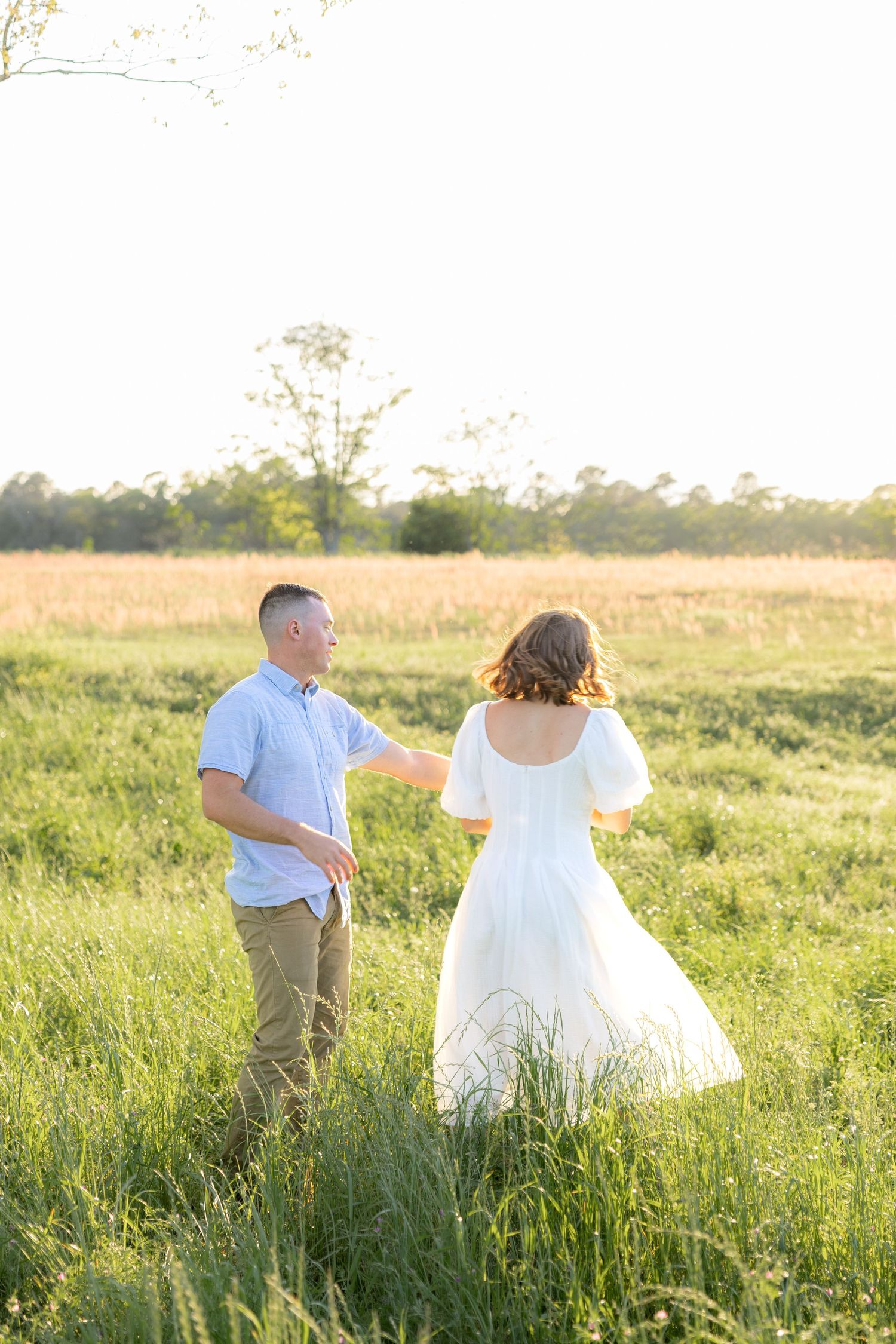 Storytelling couple photos in a tall grass field at sunset in Dothan, Alabama