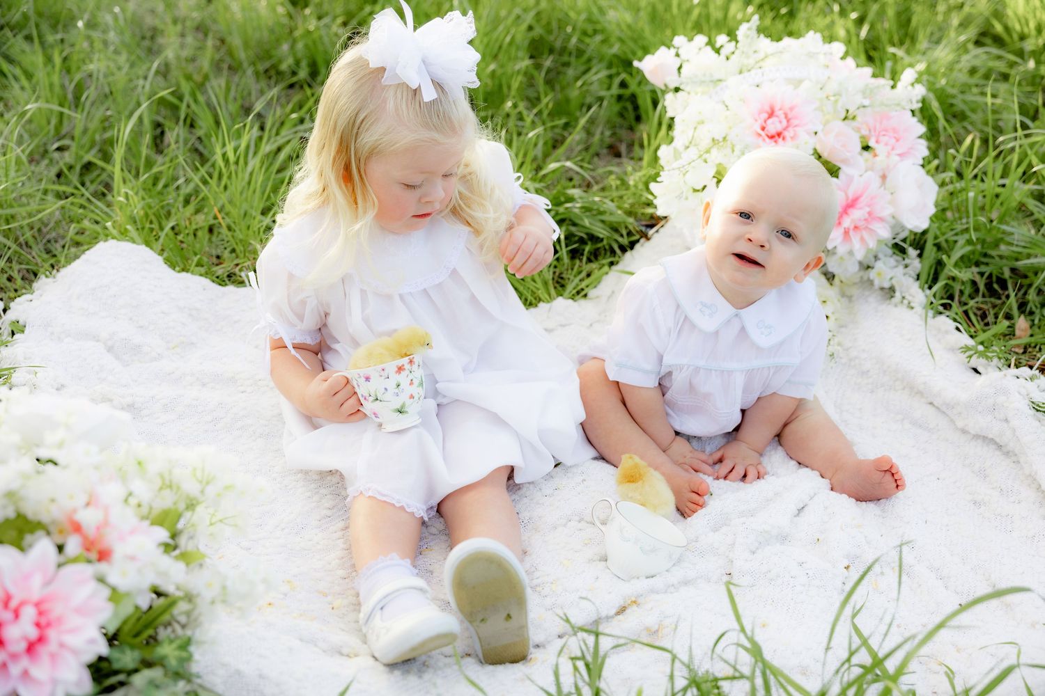 Spring Mini Session with baby chicks in a grass field at sunset near Dothan, Alabama