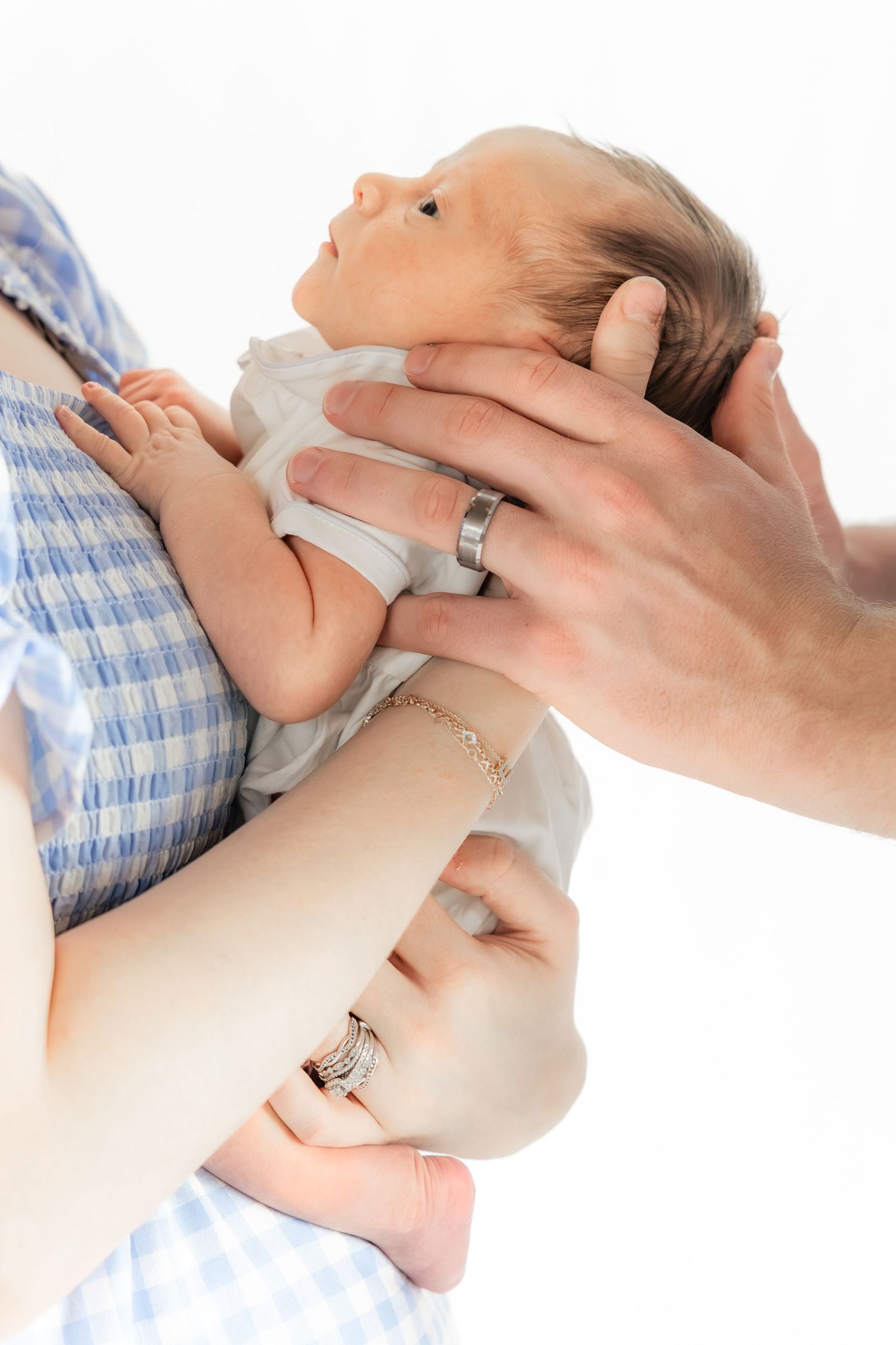 Family holding their newborn in a studio in Dothan, Alabama