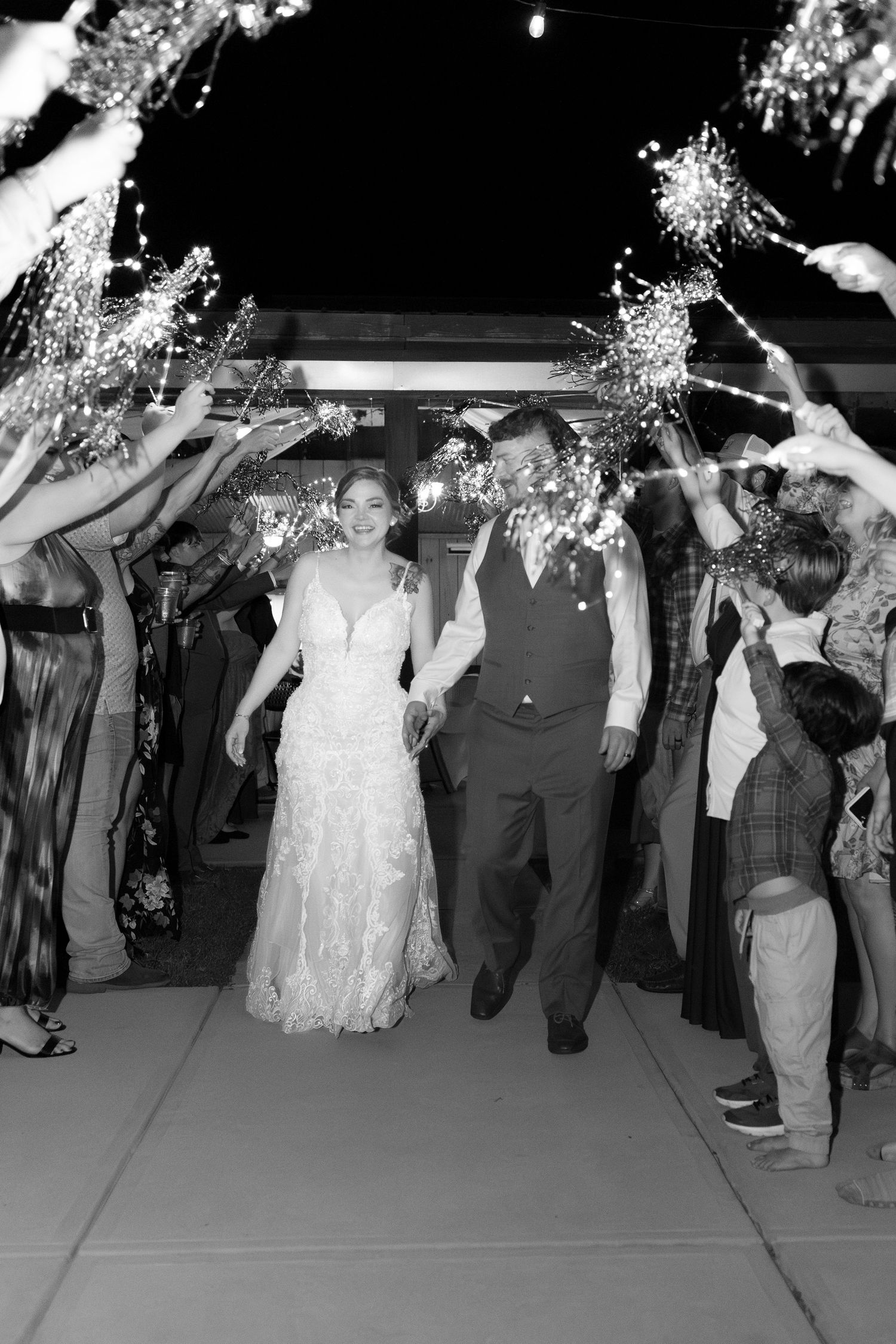 Bride and groom exit through sparklers at their wedding at Hilltop Acres Wicksburg, Alabama