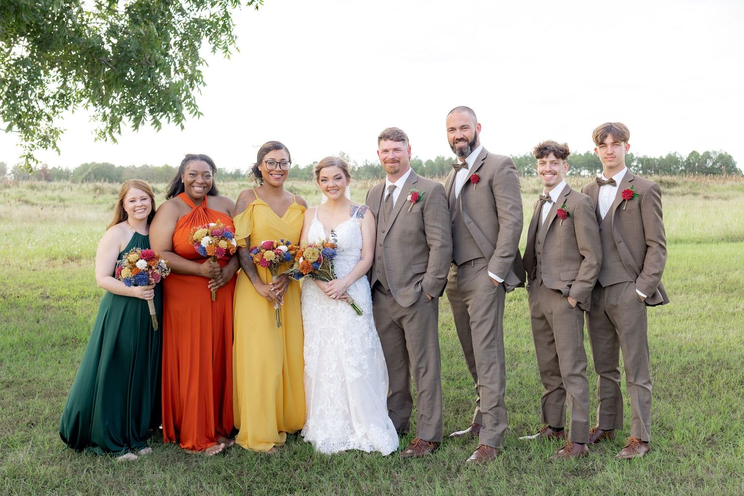 Bridal party posing in a field at sunset at Hilltop Acres Wicksburg, Alabama