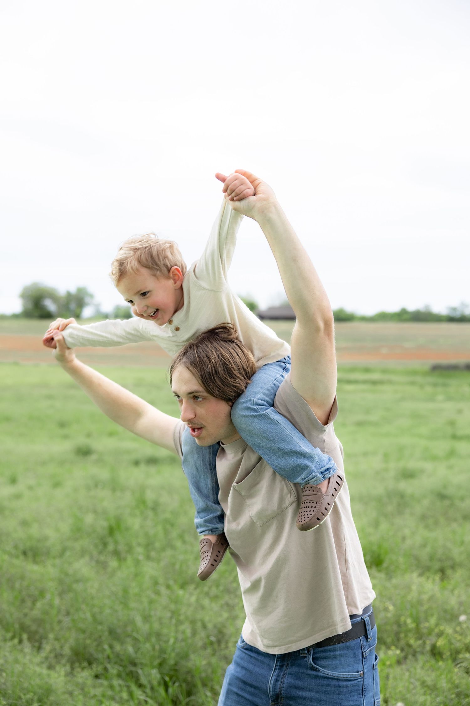 Candid family photos in a grass field | Dothan, Alabama Lifestyle Portrait Photographer