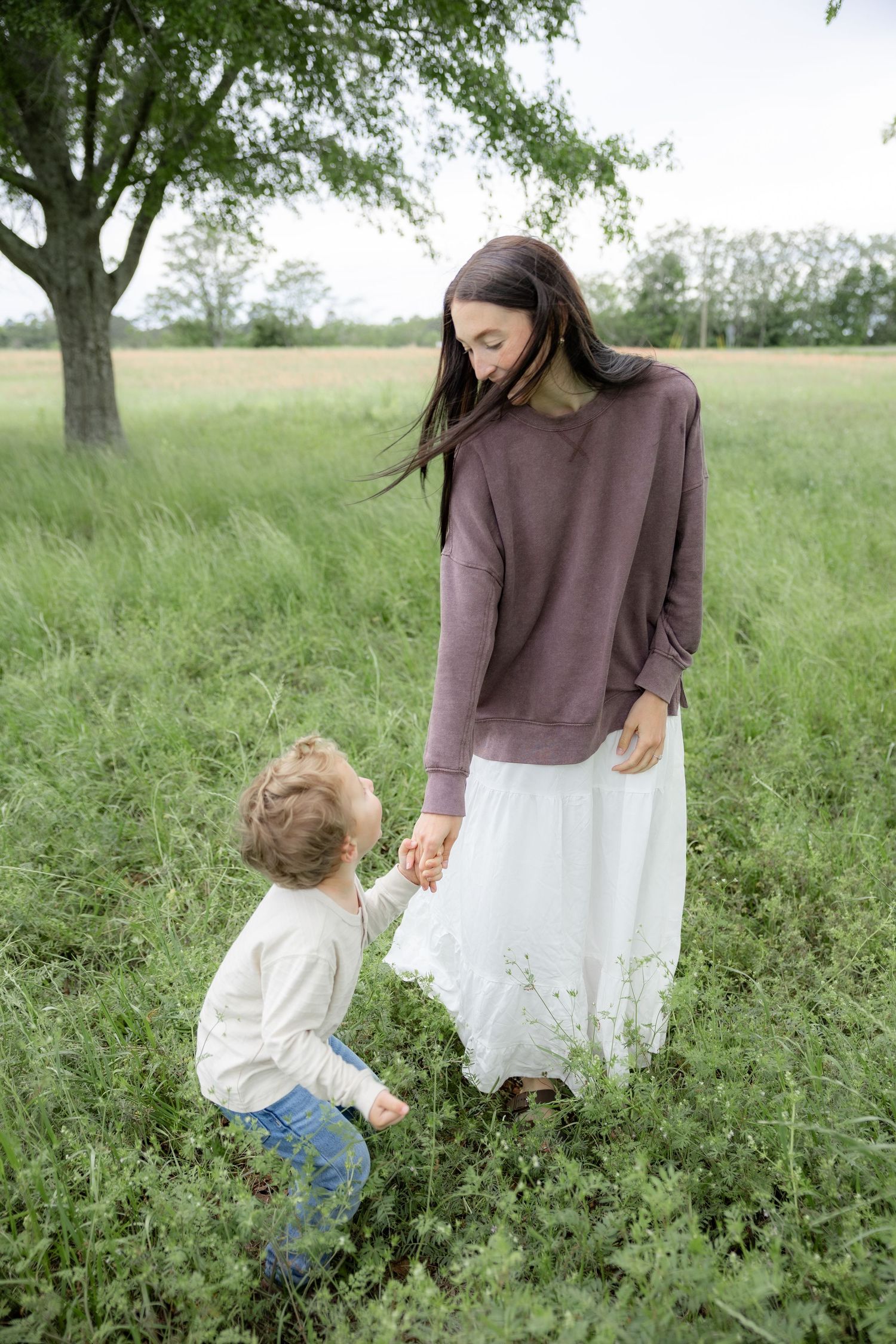 Candid family photos in a grass field | Dothan, Alabama Lifestyle Portrait Photographer