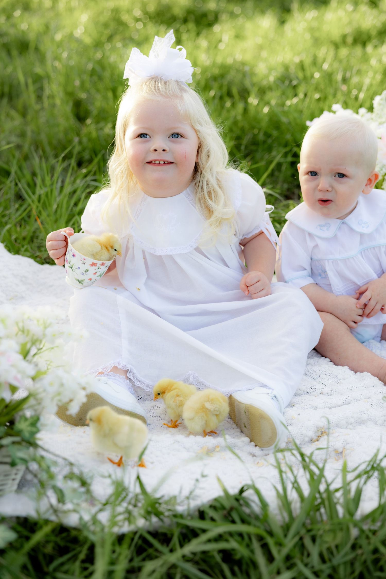 Spring Mini Session with baby chicks in a grass field at sunset near Dothan, Alabama