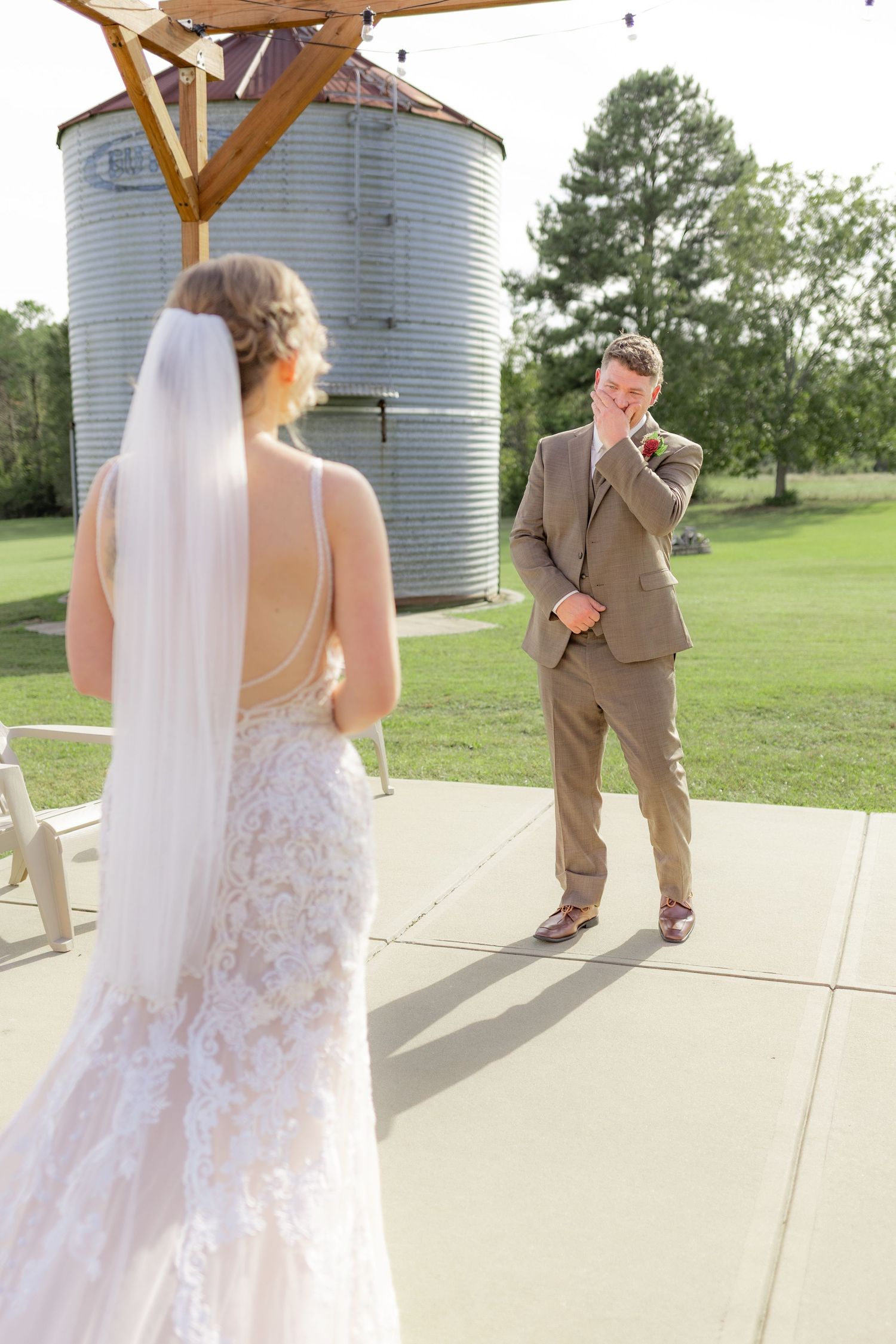 Groom first look with bride underneath the gazebo at Hilltop Acres Wicksburg, Alabama